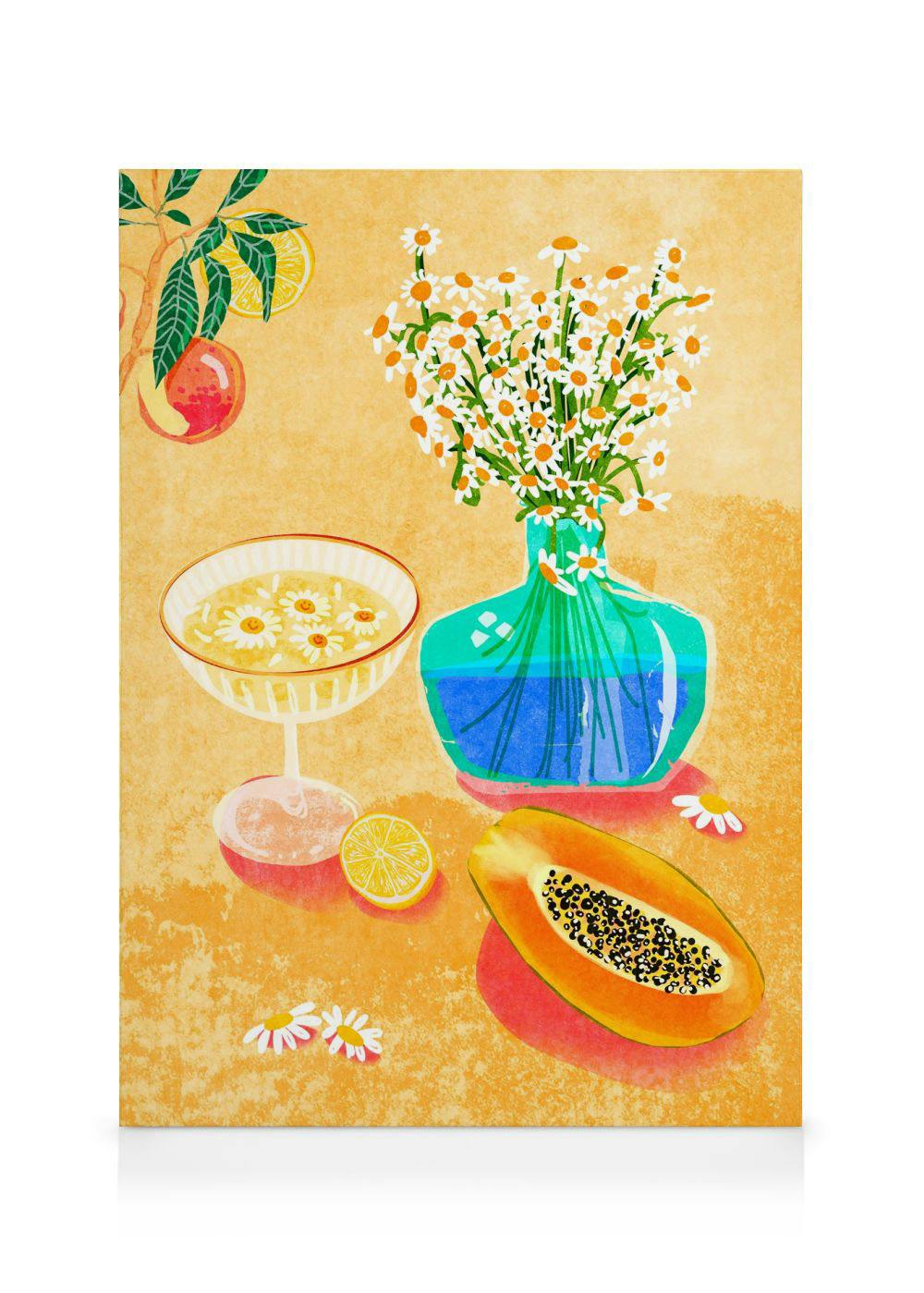 Still life canvas print with orange flowers in a vase, papaya, lemon slice, and floral bowl on yellow.