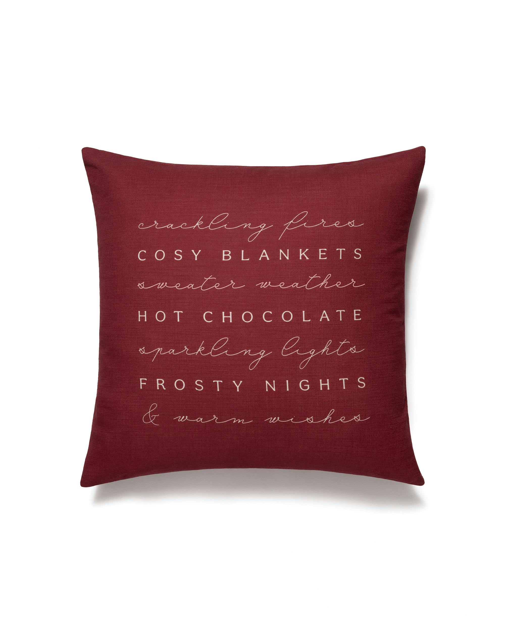 Housse de coussin rouge avec texte inspirant blanc, typographie variée pour ambiance festive. Idéale pour le salon.