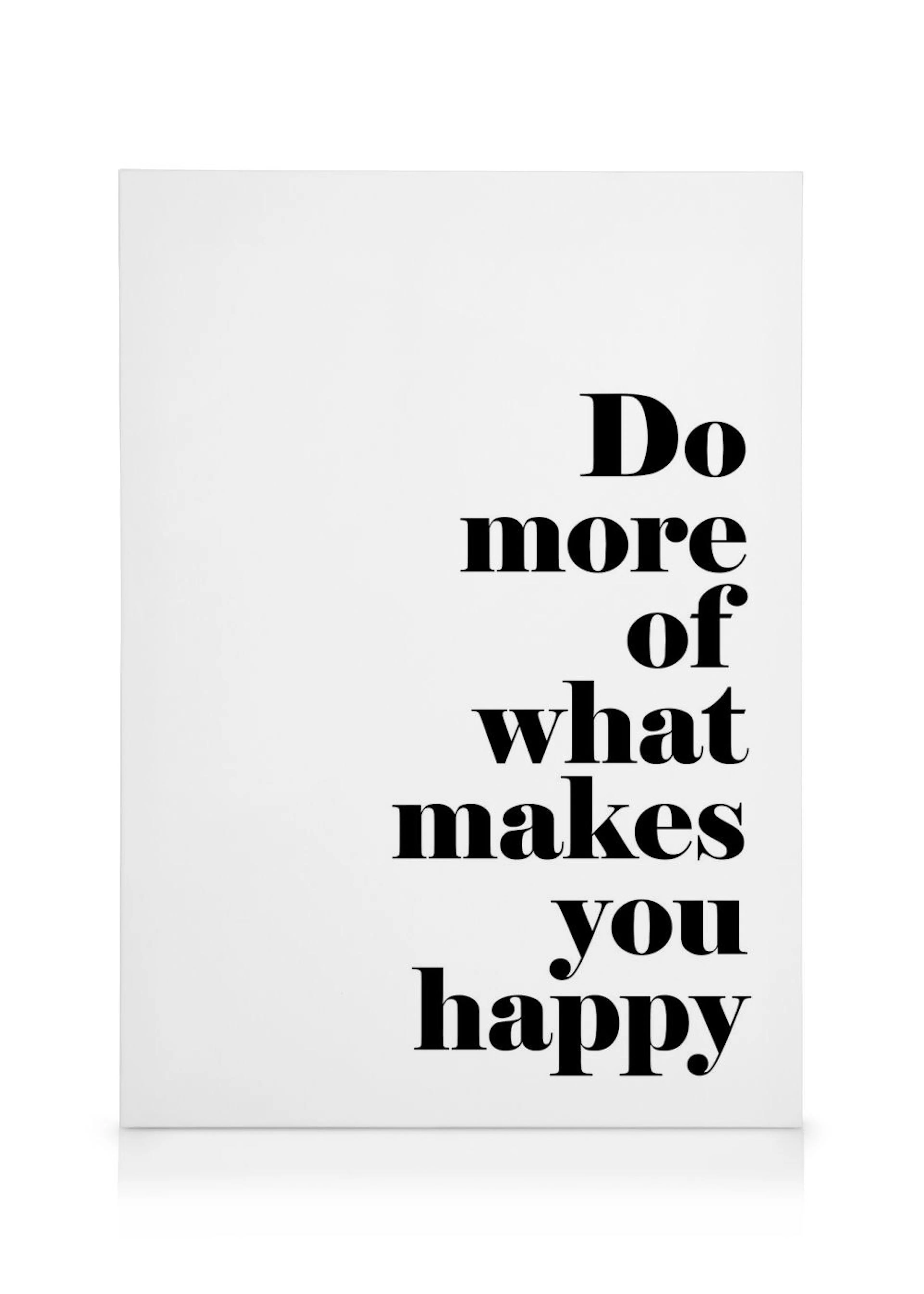 Stampa su tela bianca con la citazione Do More Of What Makes You Happy in testo nero, tipografia moderna