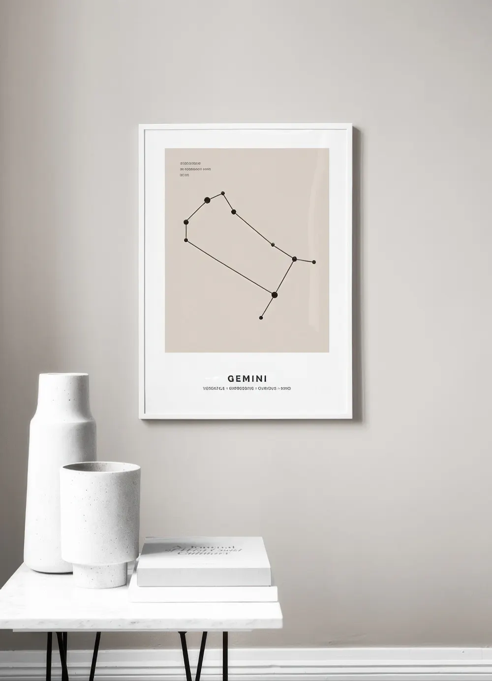 A personalised print of the Gemini constellation on a light beige background, displayed on a light grey wall above a white side