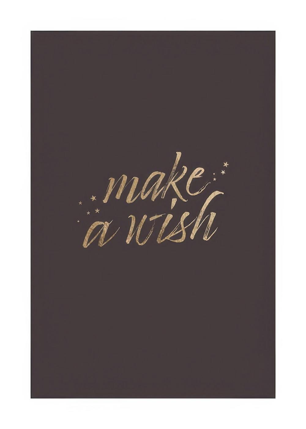Plakát s textem Make a wish ve zlaté barvě na šedém pozadí se třpytivými hvězdami, moderní typografie.
