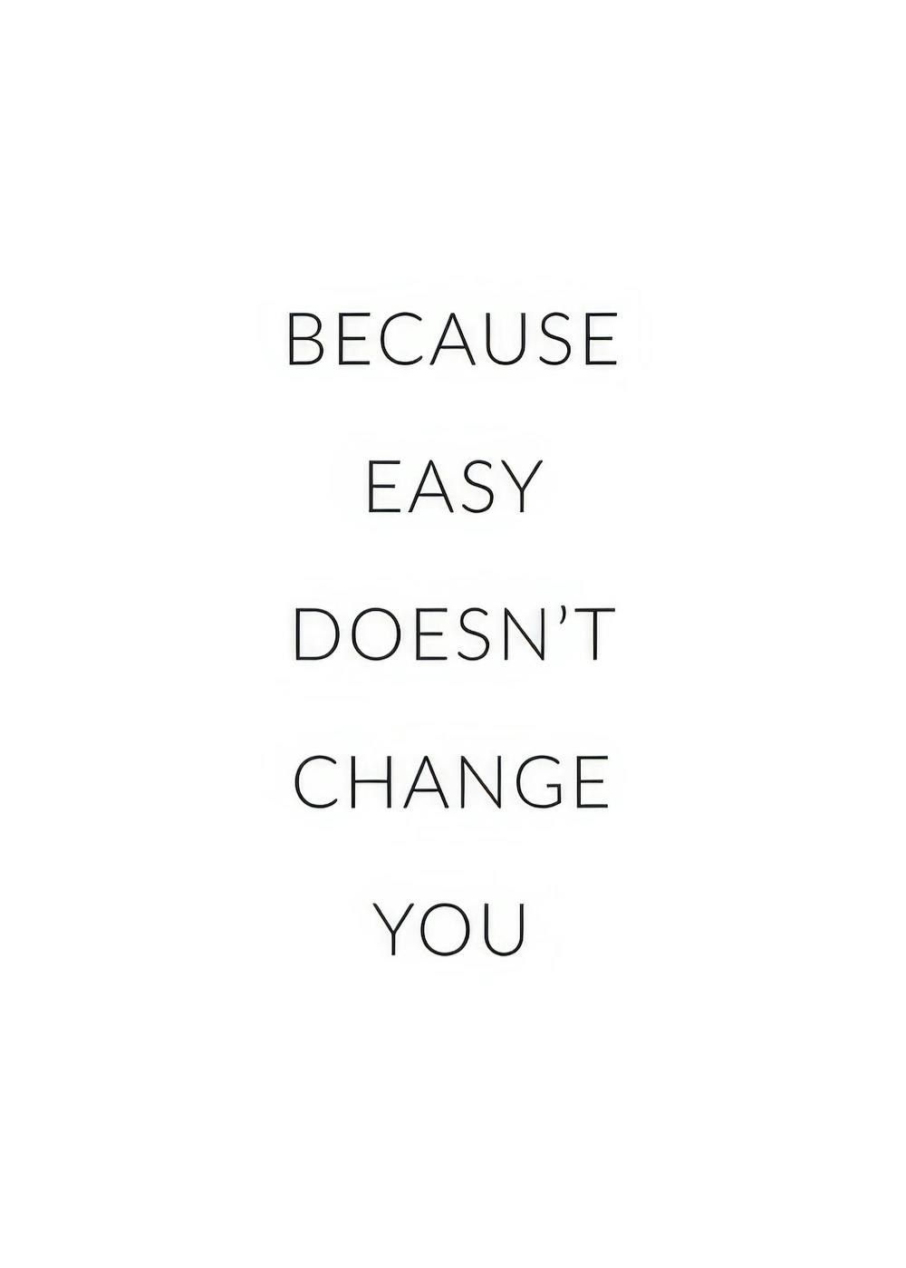 A motivational print with the words BECAUSE EASY DOESNT CHANGE YOU displayed on a windowsill next to books and a vase.