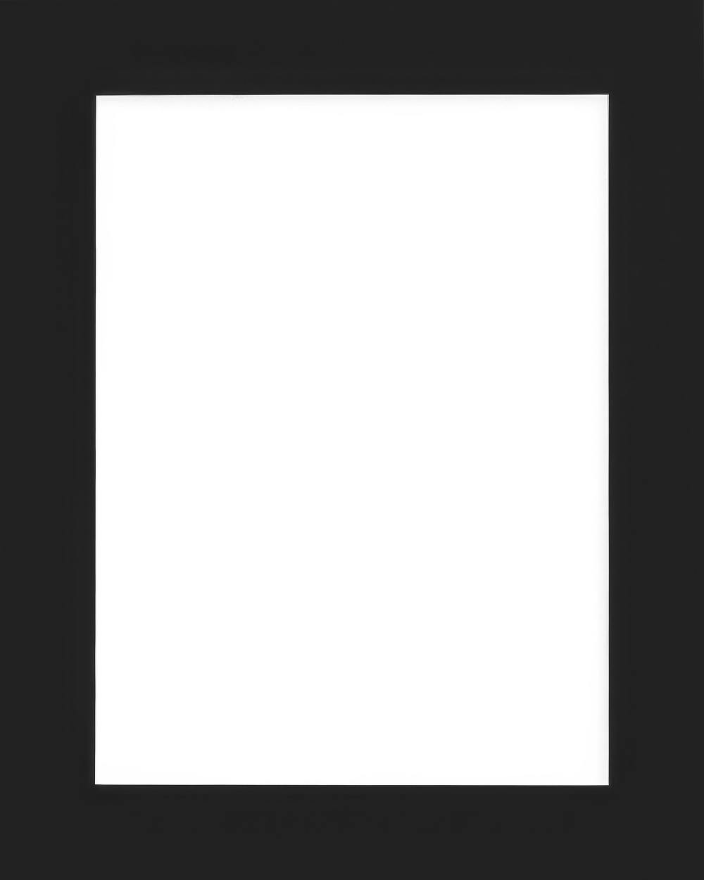 Black mat board with a white rectangular opening, centered on the board. Passepartout for framing artwork.