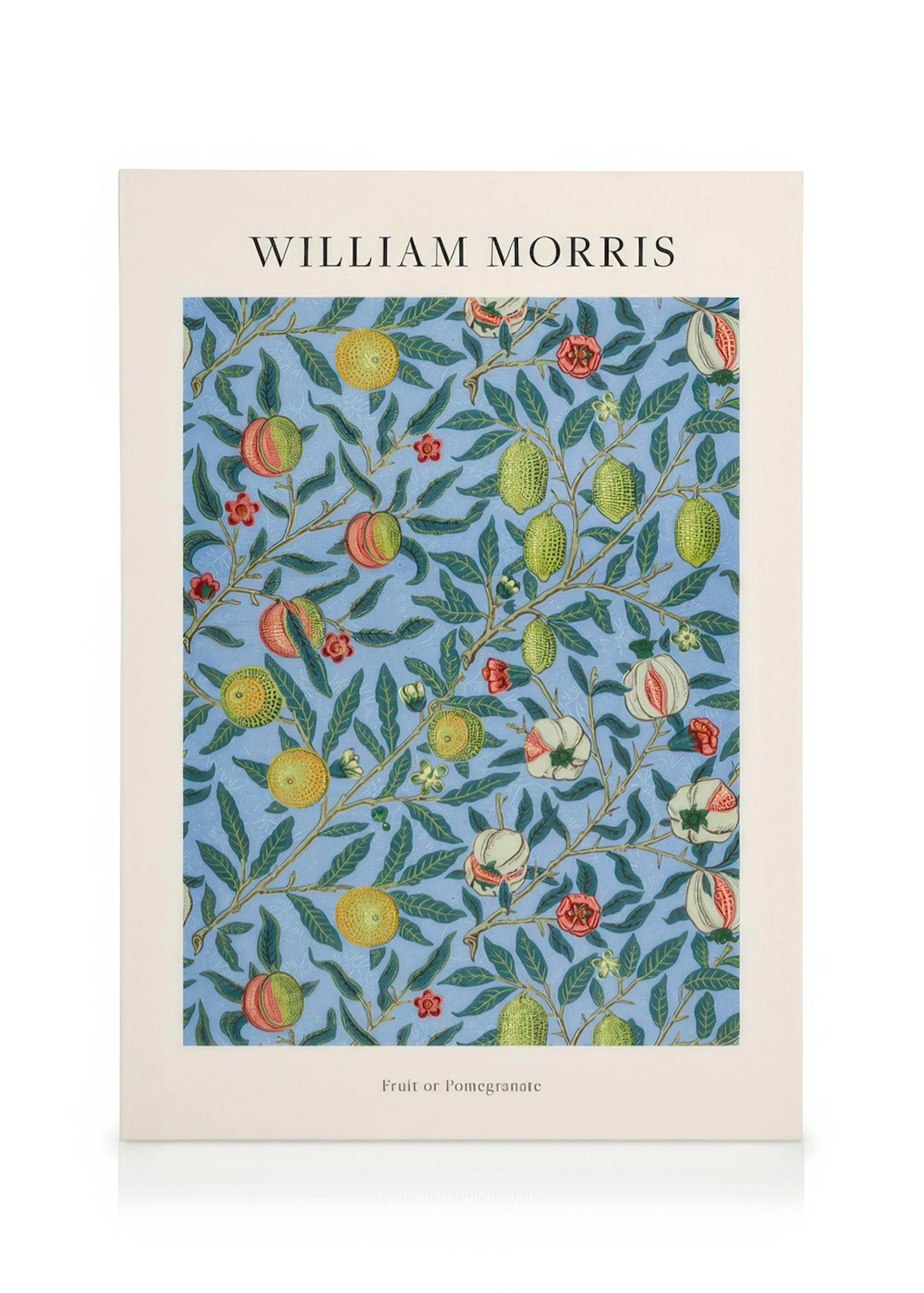 A William Morris canvas print with green leaves, yellow and red fruits on a blue background, hanging above a wooden console tabl