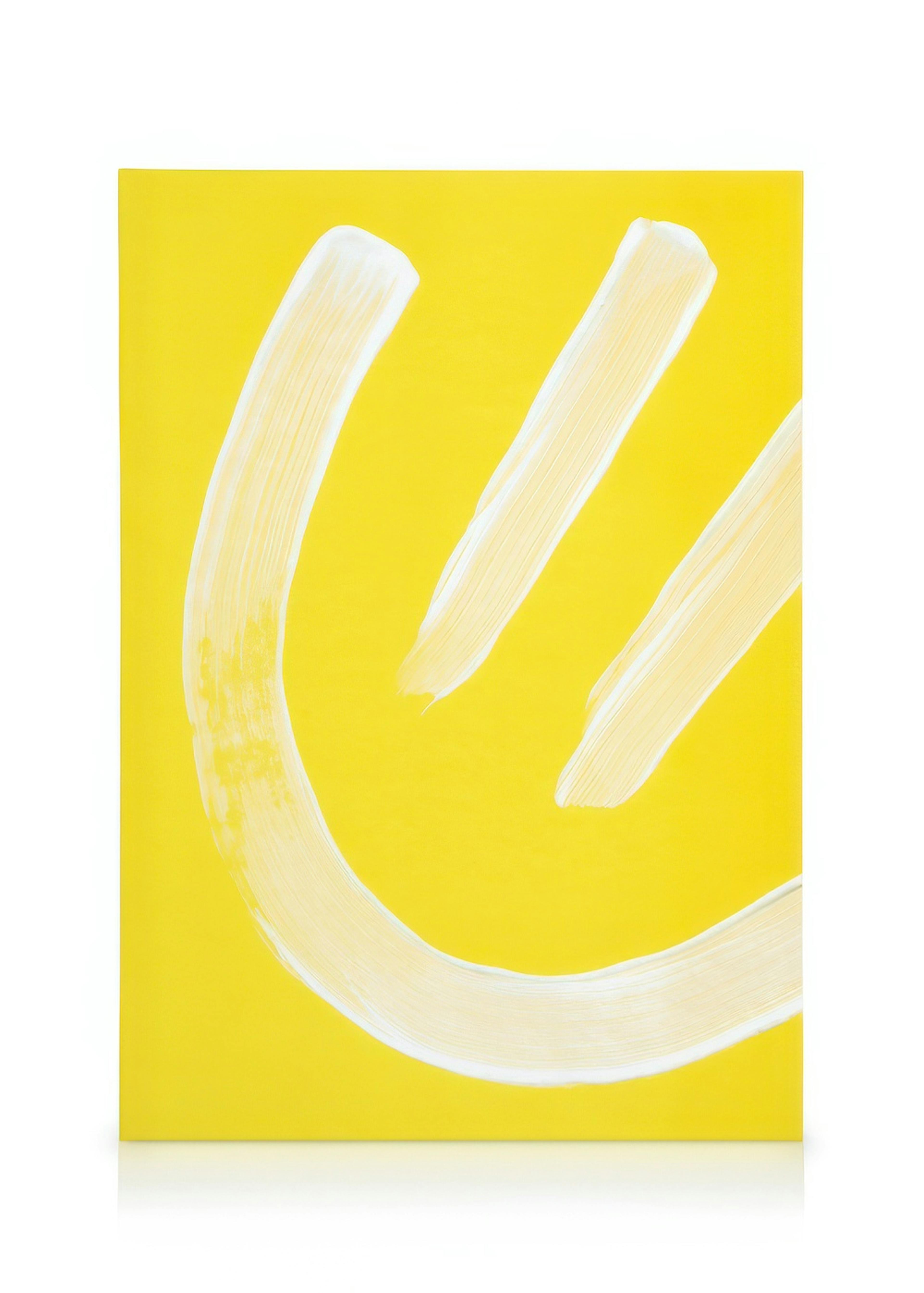 Yellow smiley face graphic on canvas print, featuring a curved smile and two slanted eyes created with white brushstrokes.