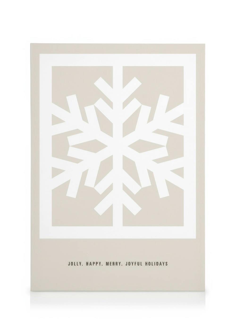 Graphic snowflake canvas print with white cutout snowflake on beige, Jolly, Happy, Merry, Joyful Holidays text.