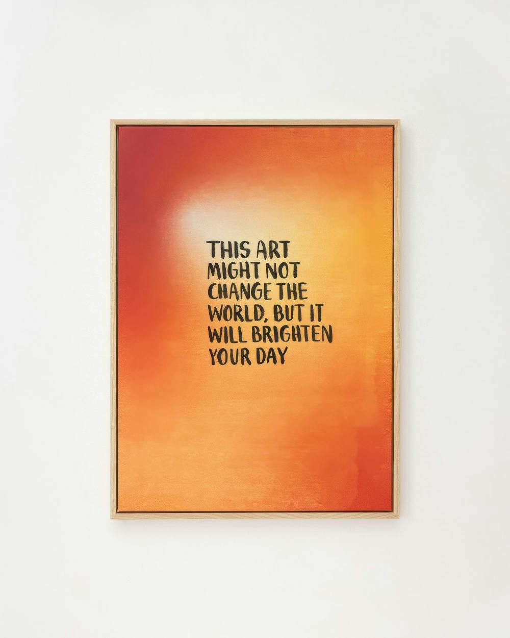 Lienzo con fondo degradado naranja y rojo, y la frase THIS ART MIGHT NOT CHANGE THE WORLD, BUT IT WILL BRIGHTEN YOUR DAY en negr