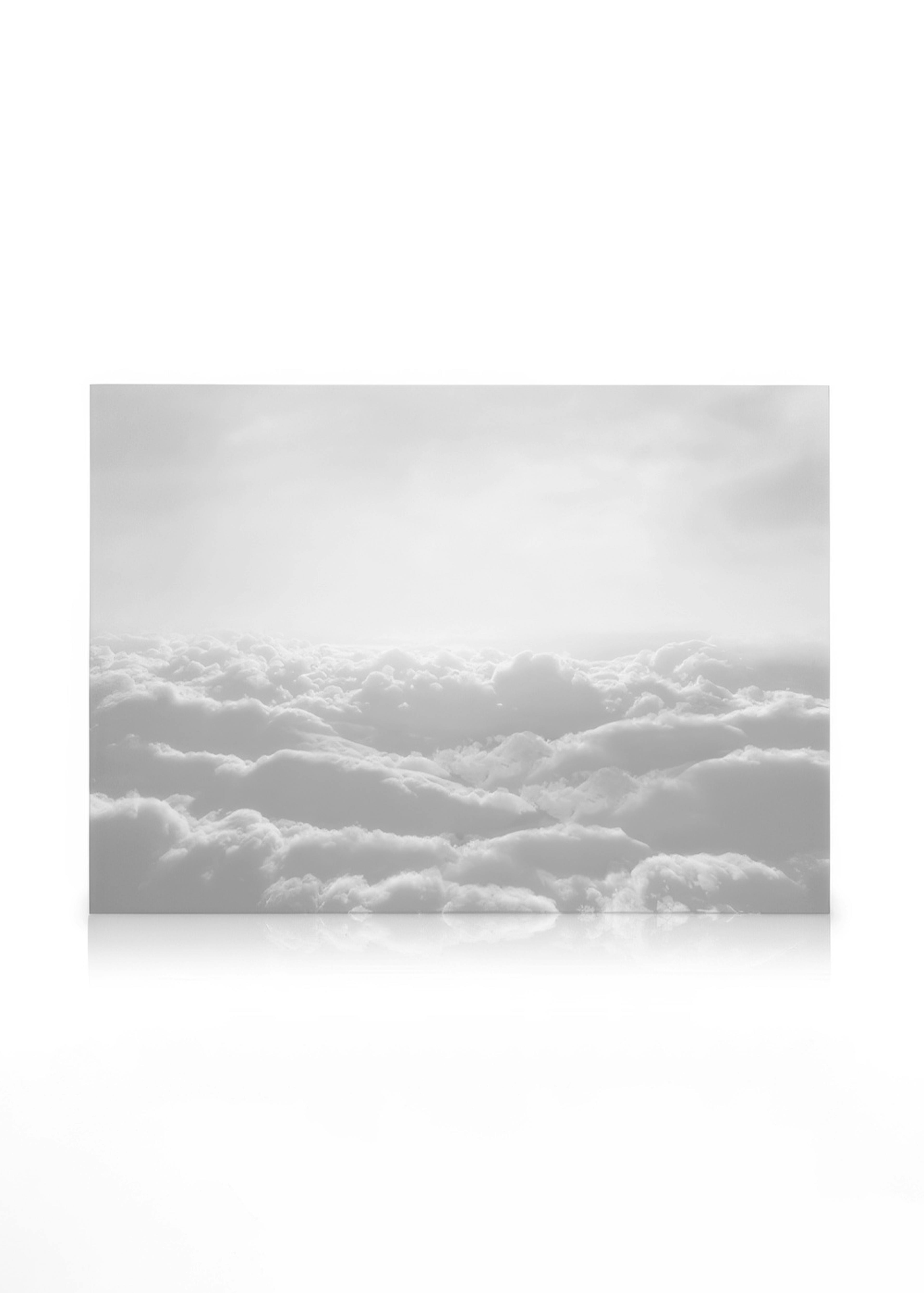 Monochromatic canvas art of fluffy white clouds filling the sky, with a subtle horizon line and soft light from above.