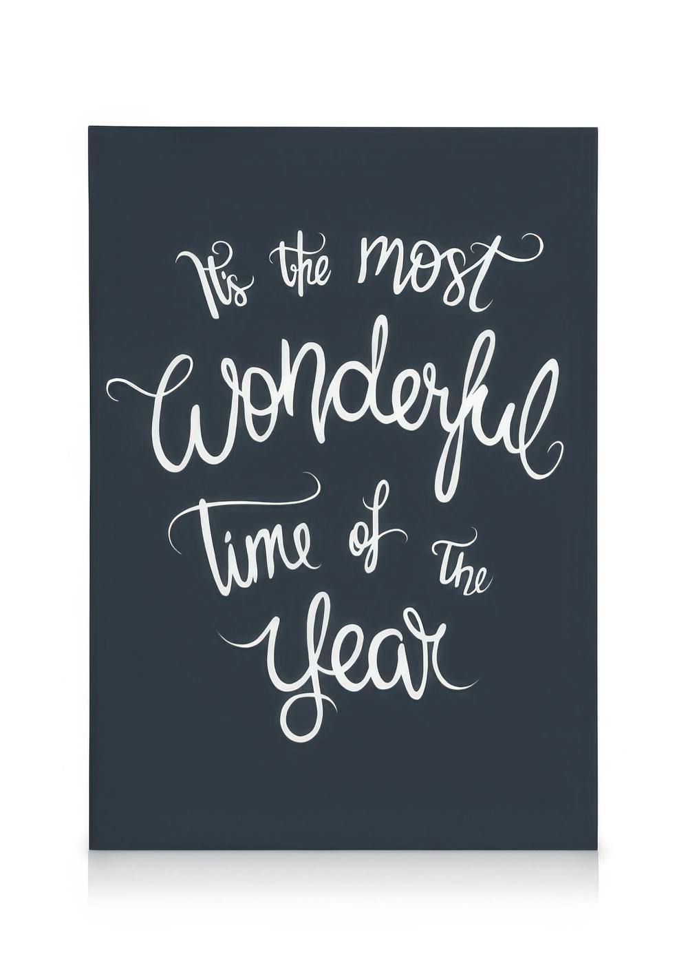 Dark blue canvas print with Its The Most Wonderful Time Of The Year in white cursive text, festive wall art.