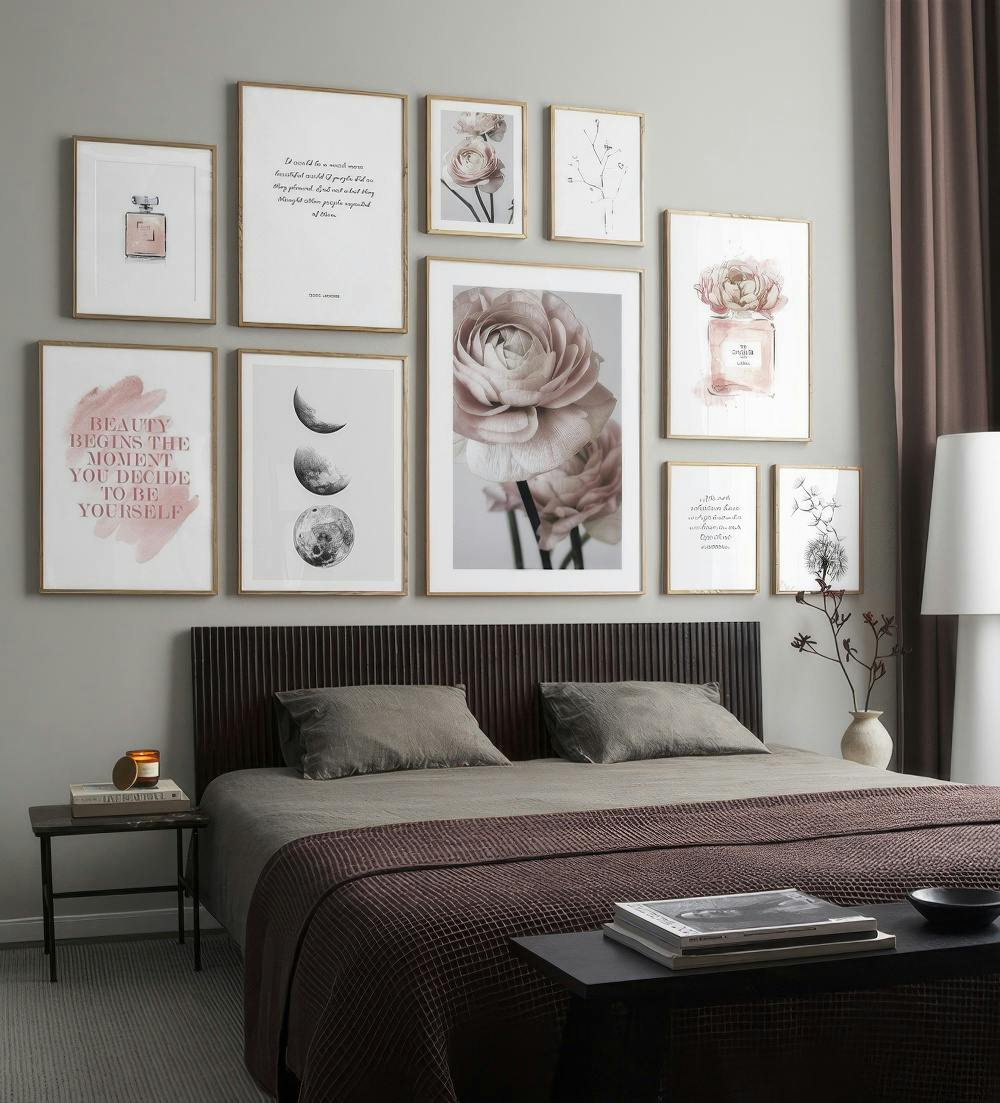 En tavelvägg med motiv av rosa blommor, parfymer, månfaser, en maskros och inspirerande citat i en sovrumsmiljö.
