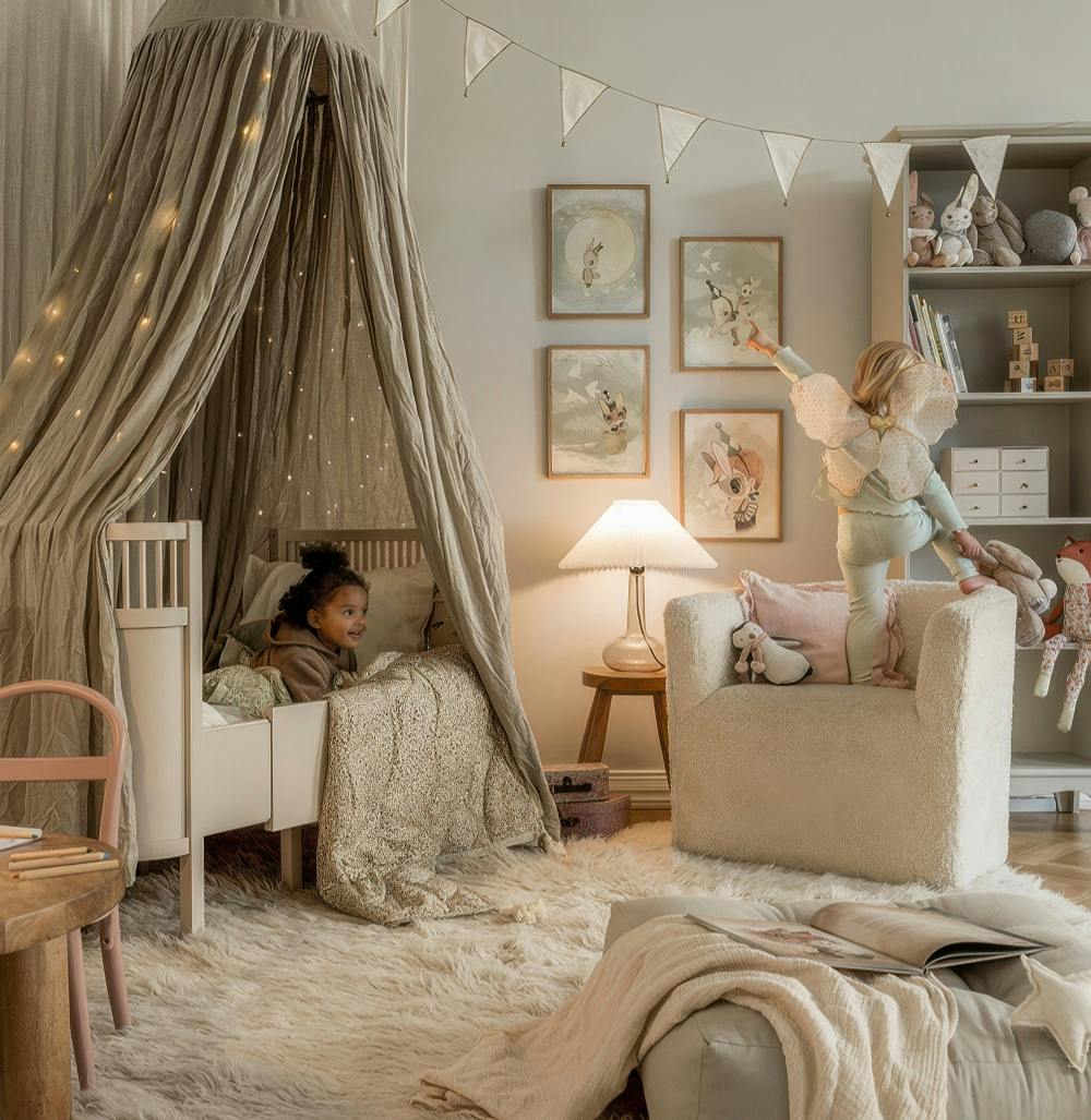A gallery wall with four framed prints, each featuring a whimsical animal character on a neutral background, in a childs bedroom