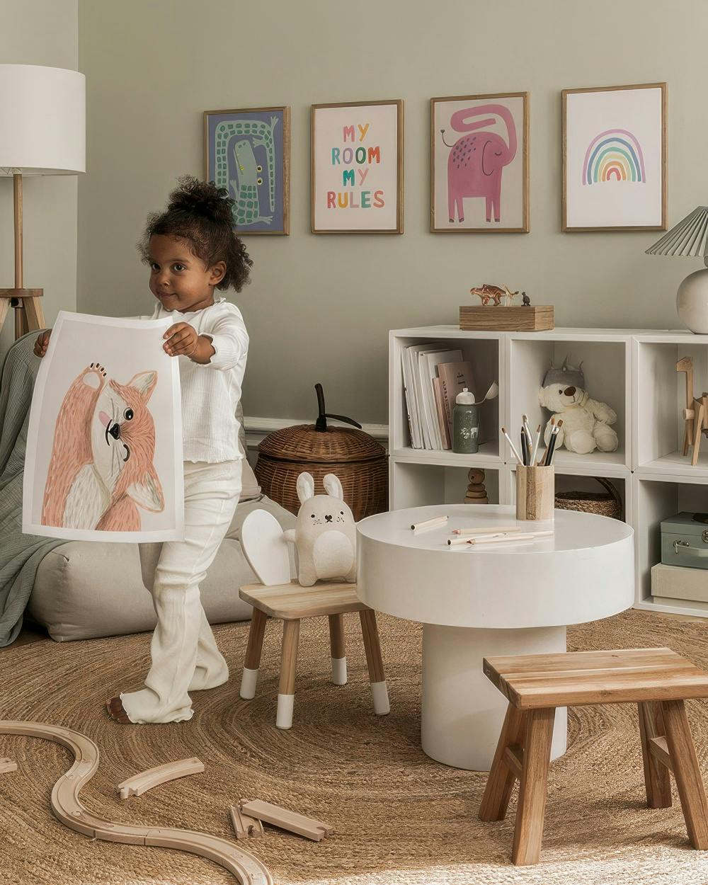 A gallery wall featuring playful animal and phrase posters, including a blue crocodile, My Room My Rules, a pink elephant, and a