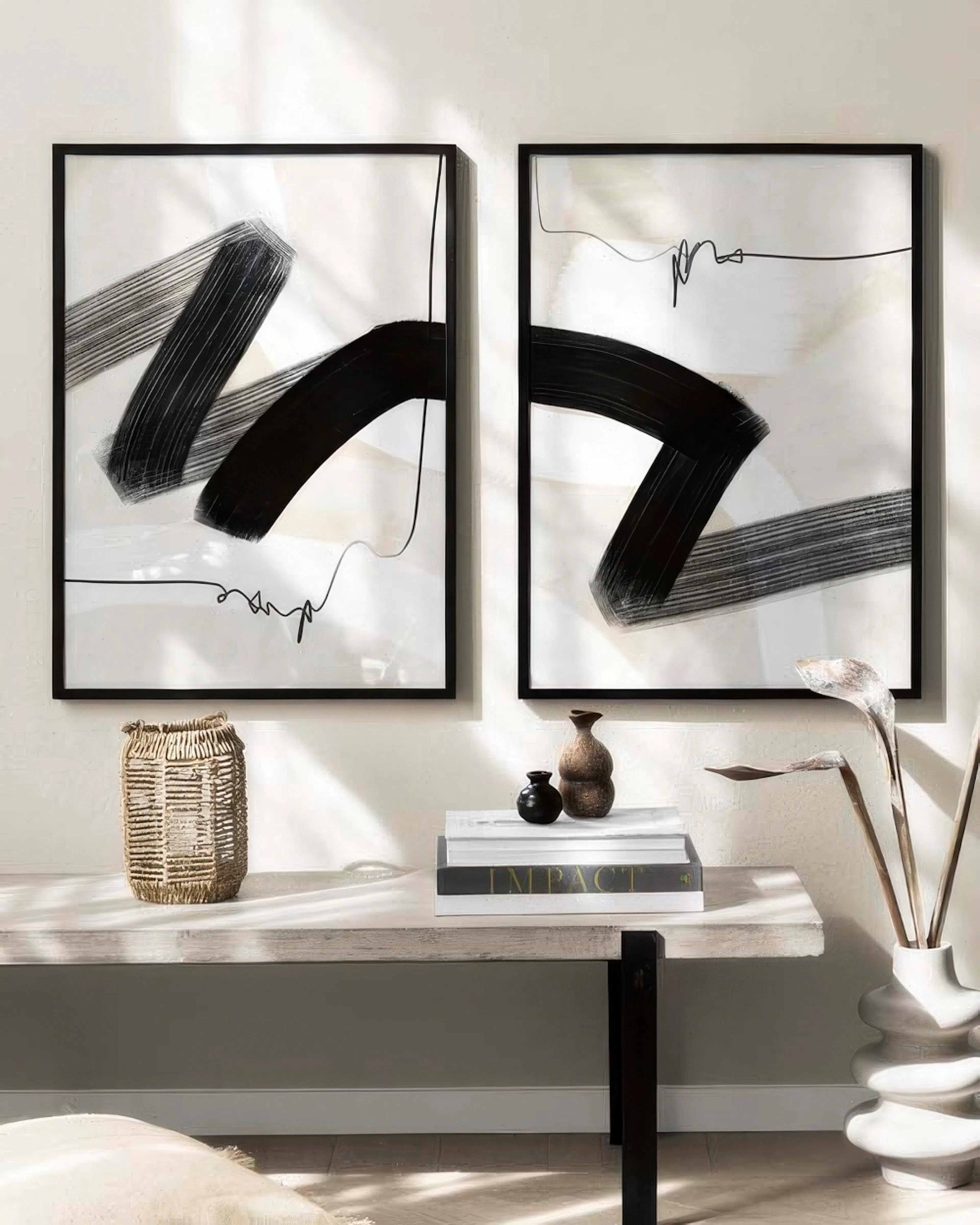 A poster pack featuring two abstract prints with bold black brushstrokes and thin lines on a light background.