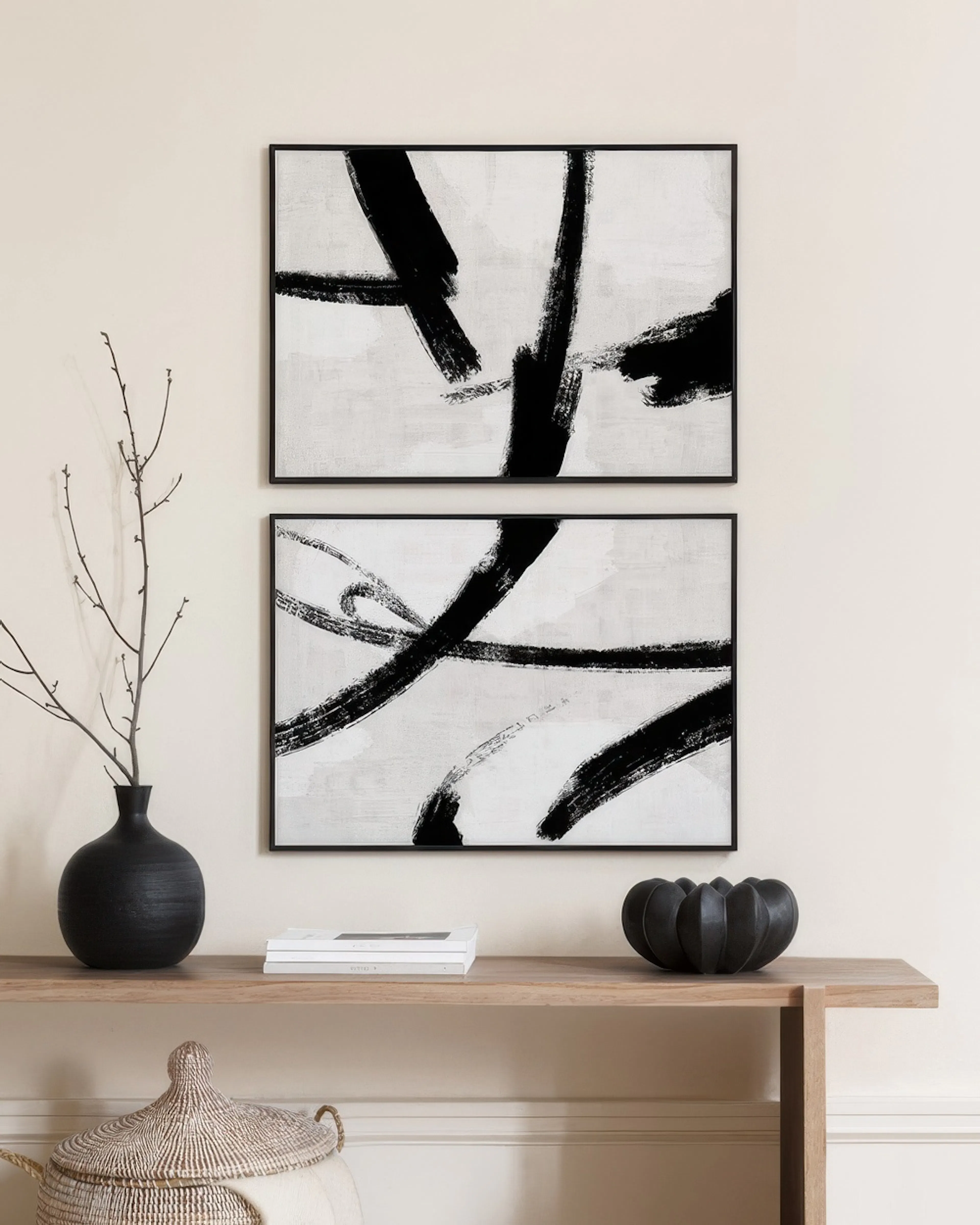 A poster pack featuring two abstract prints with broad black brushstrokes on a distressed white and gray background.