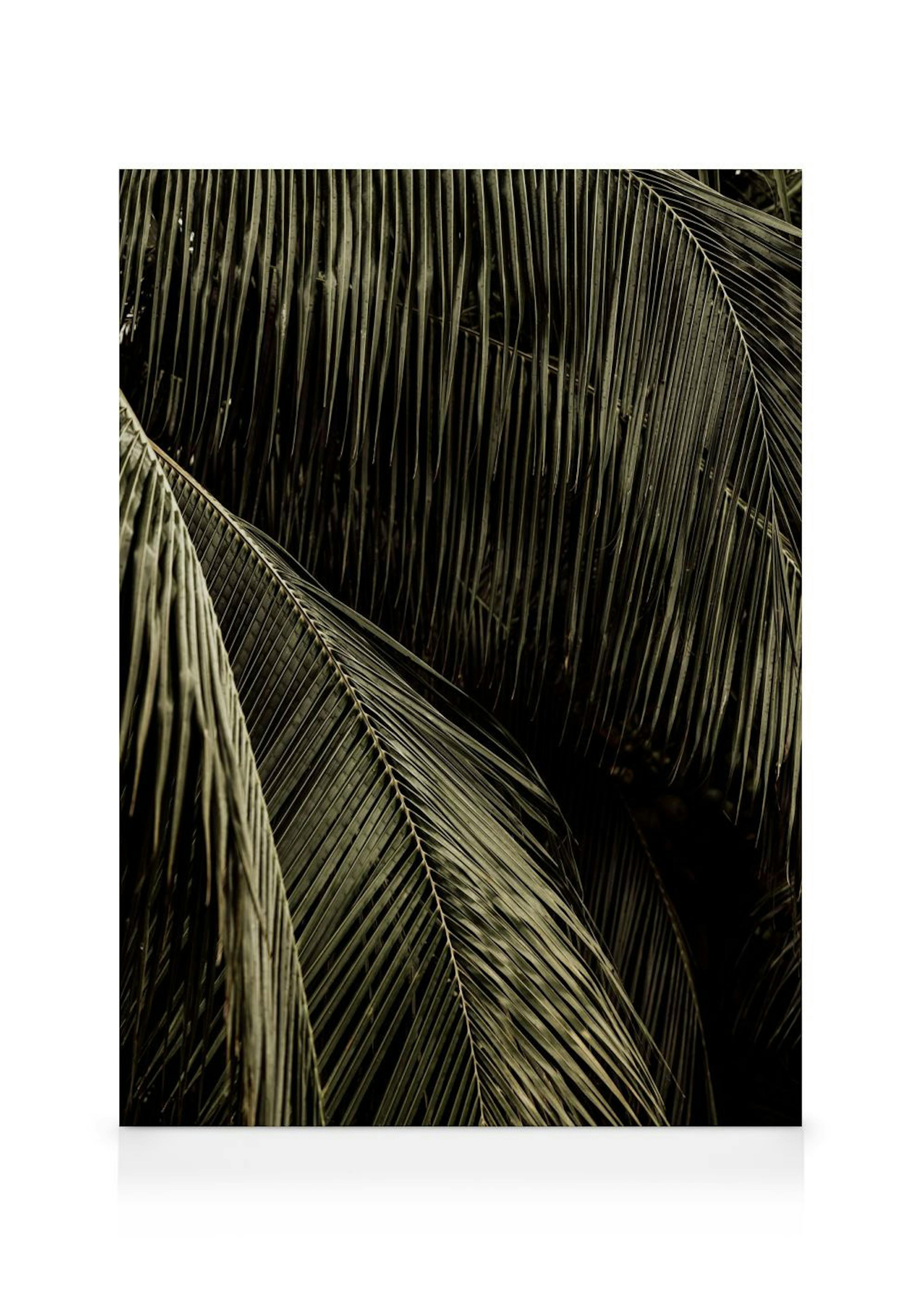 Lienzo vertical con hojas de palmera verde oscuro y beige sobre fondo oscuro, enmarcado en madera clara.
