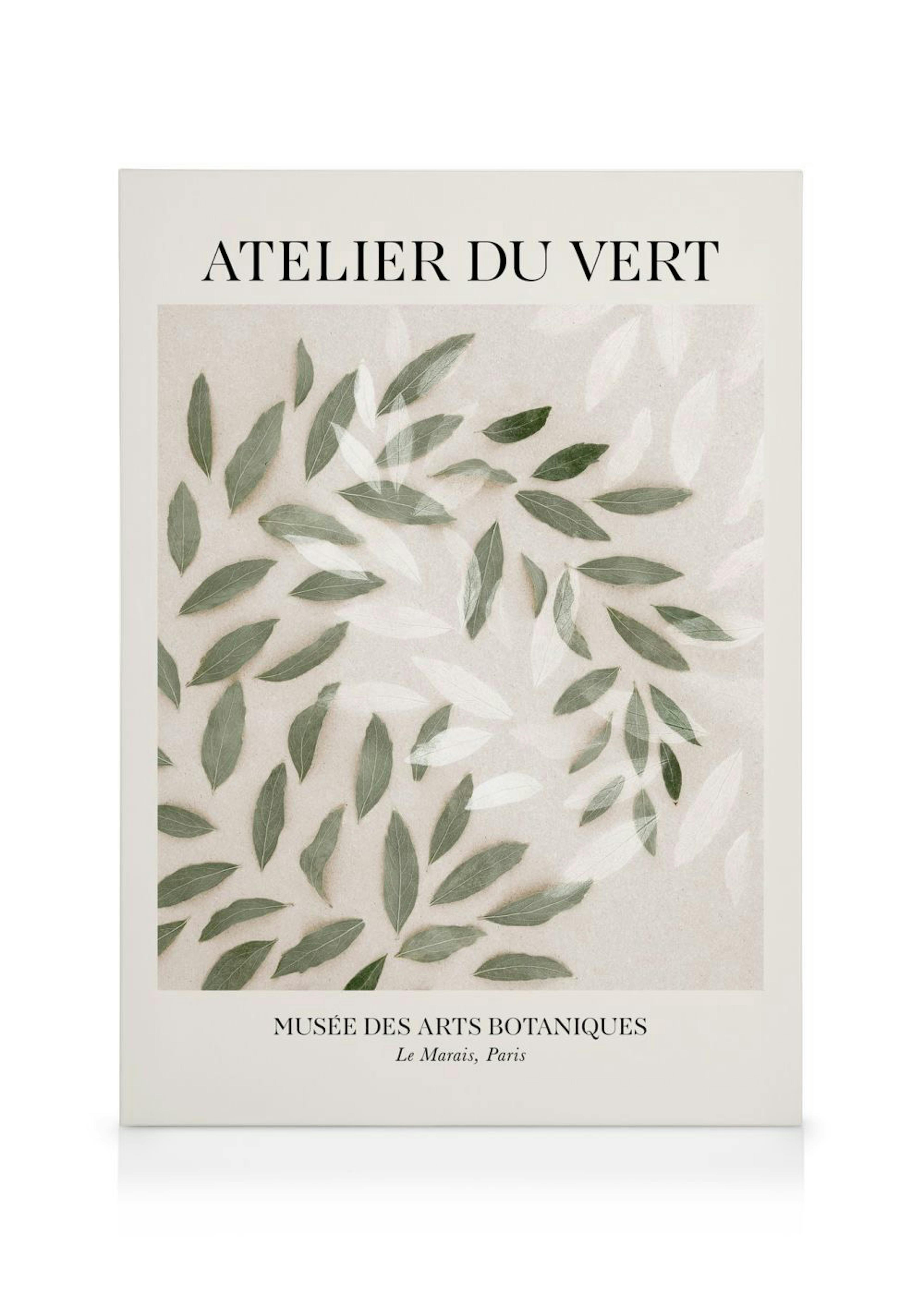 A canvas print featuring scattered green leaves and faint white leaf shapes on a beige background with French text.