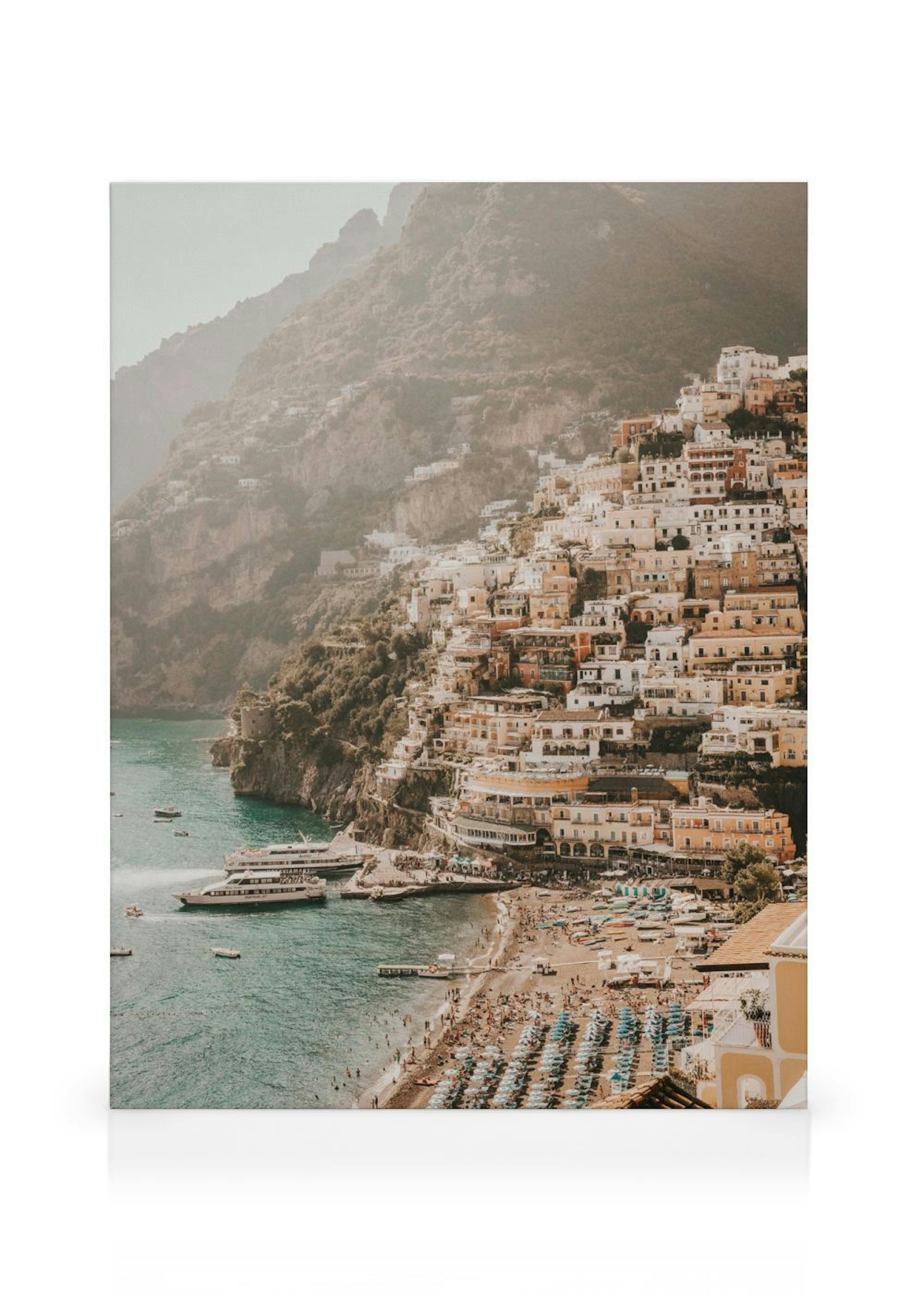 Leinwandbild der Küstenstadt Positano mit bunten Häusern am Hang, einem Strand und Booten im Meer.