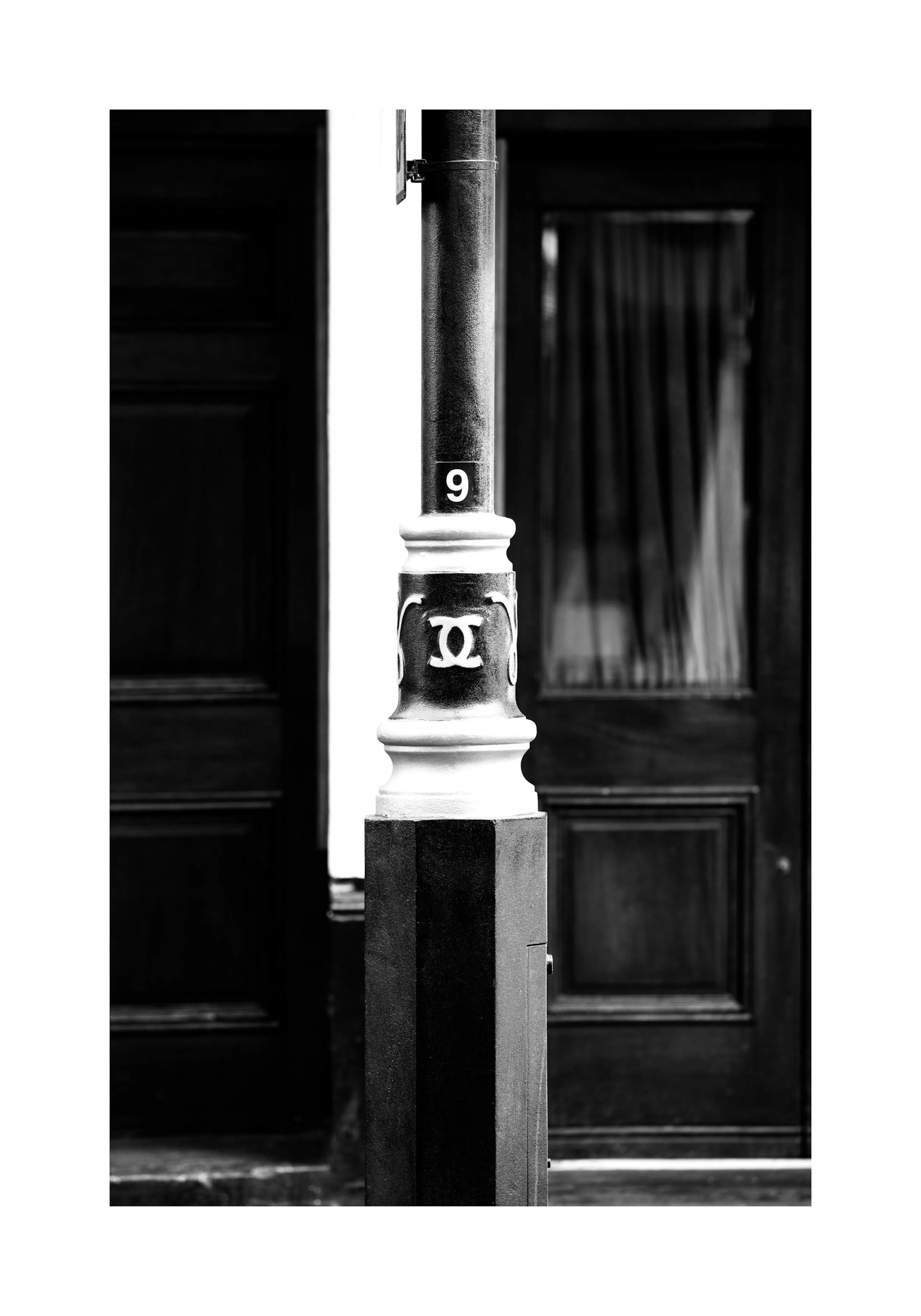 Black and white fashion poster of a London lamppost with a Chanel-inspired symbol and number 9.