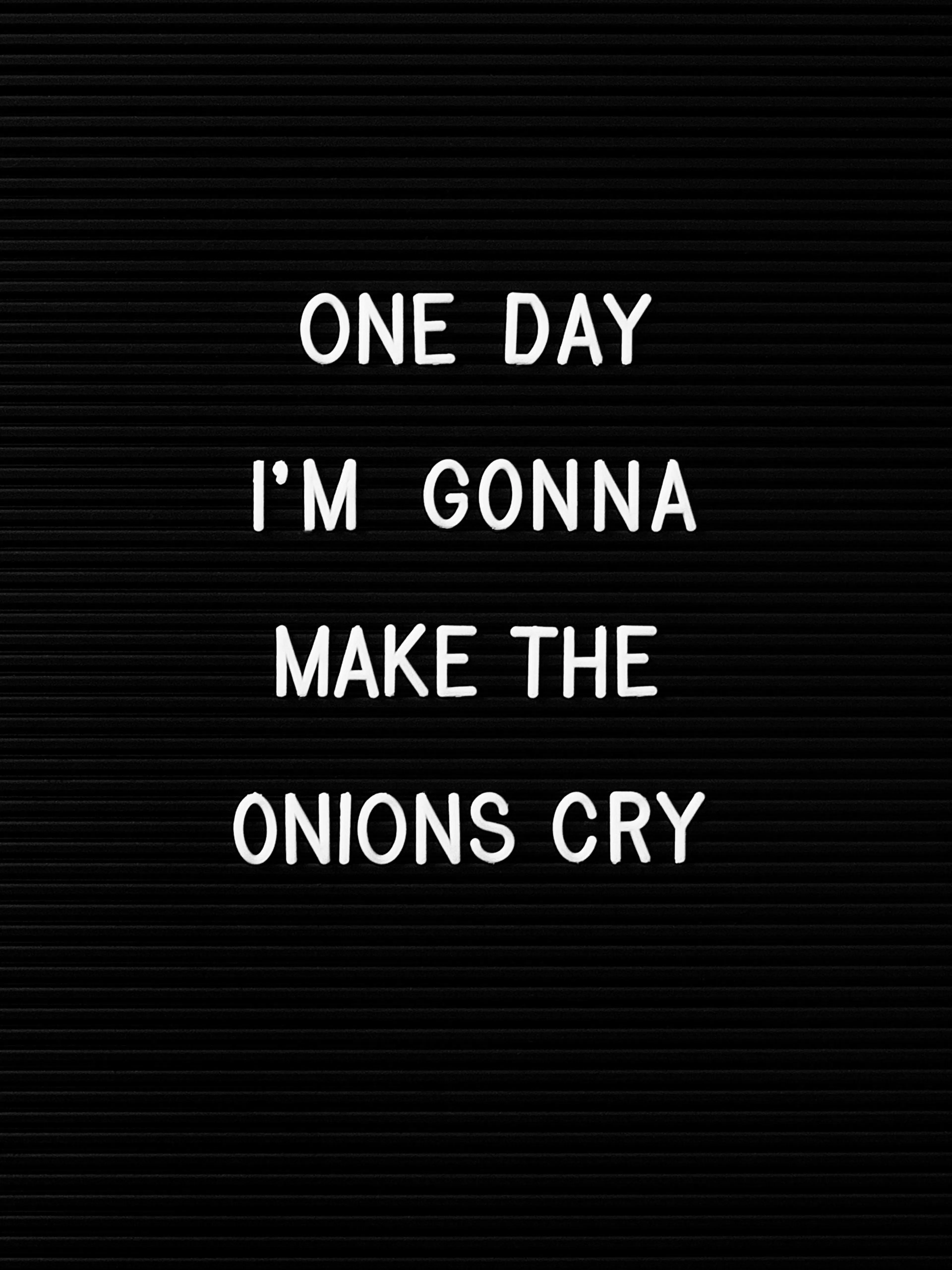 Black poster with white text: ONE DAY IM GONNA MAKE THE ONIONS CRY. Onions print, funny kitchen decor.