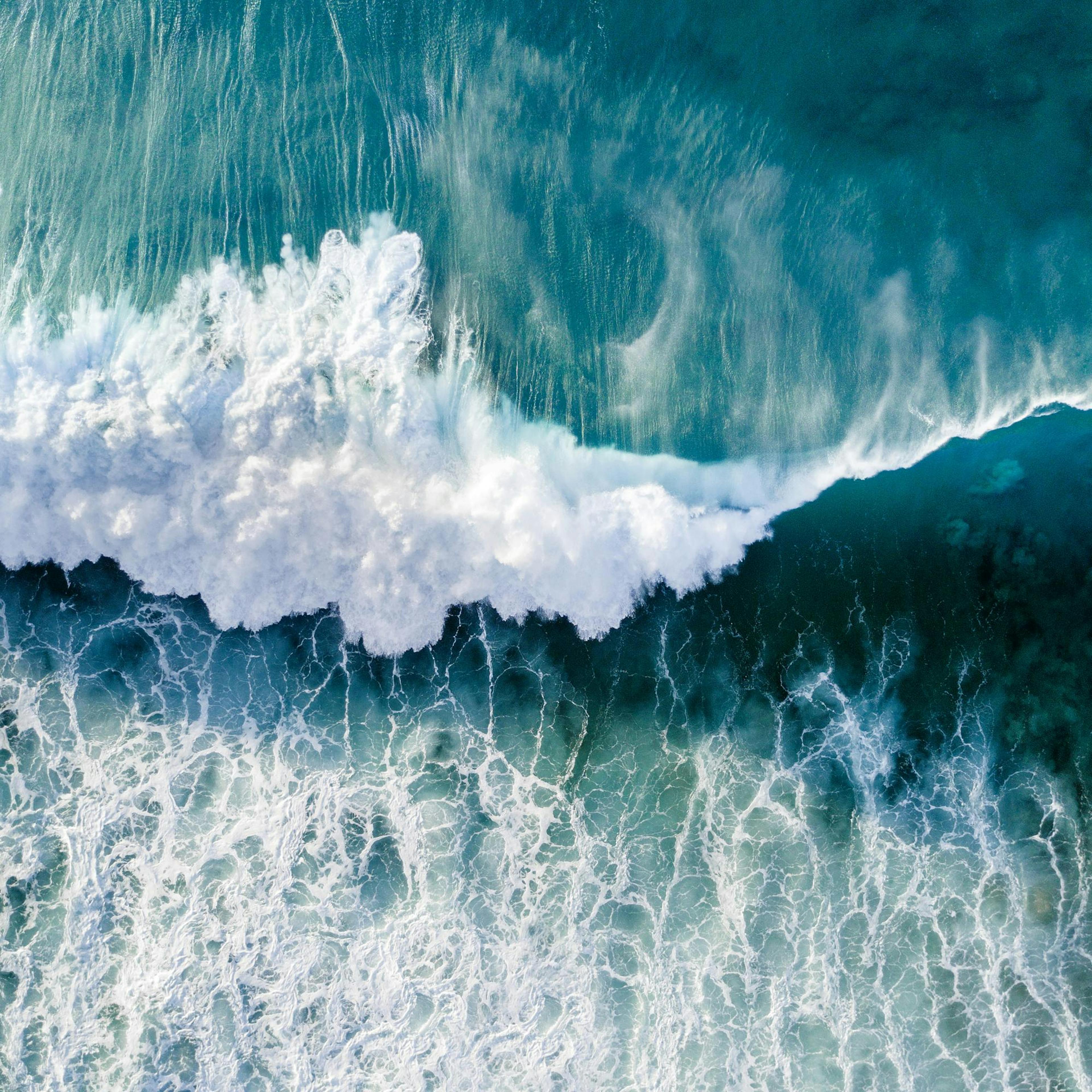 Turquoise ocean wave poster with white crashing surf, dynamic water movement, and sea foam patterns.
