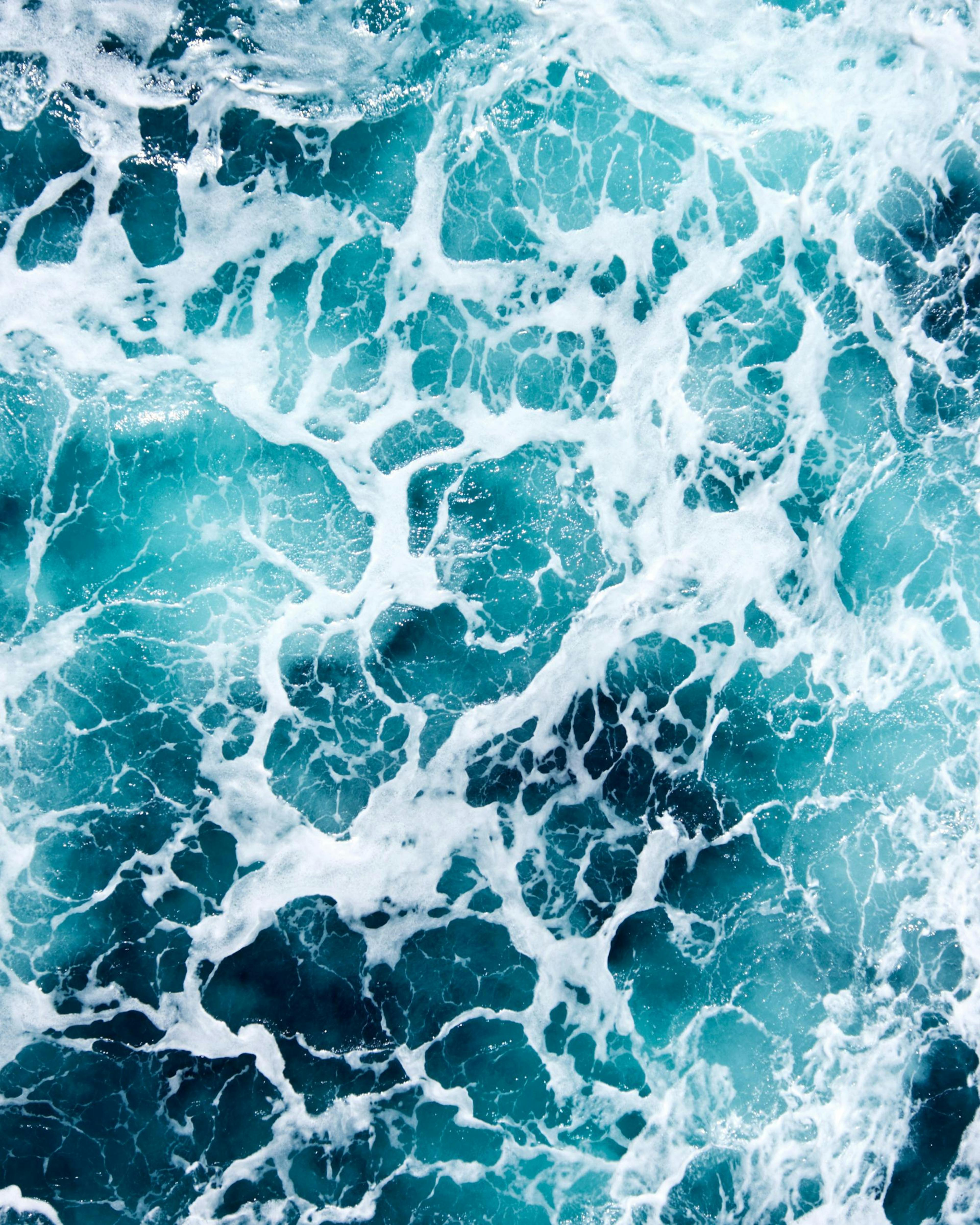 Turquoise ocean waves with white sea foam, a refreshing water print poster.
