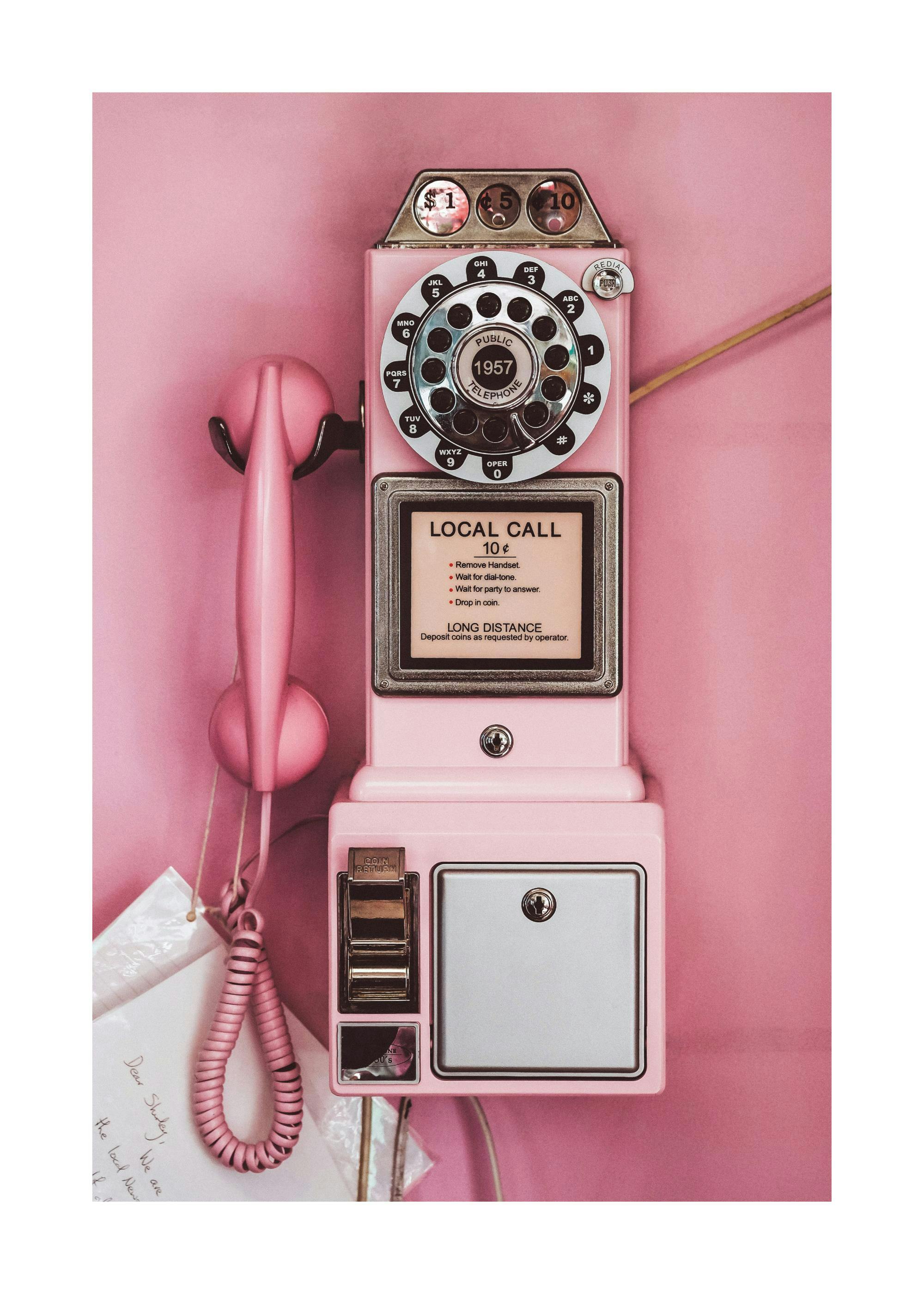 Pink retro pay phone print poster with rotary dial on a pink background, vintage style phone art print.