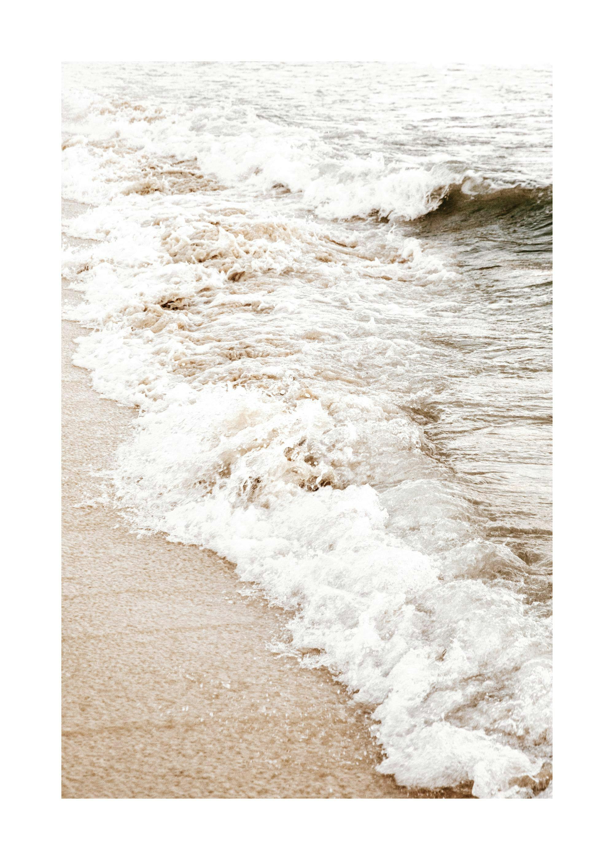 Ocean waves washing onto sandy beach, a serene nature print poster.