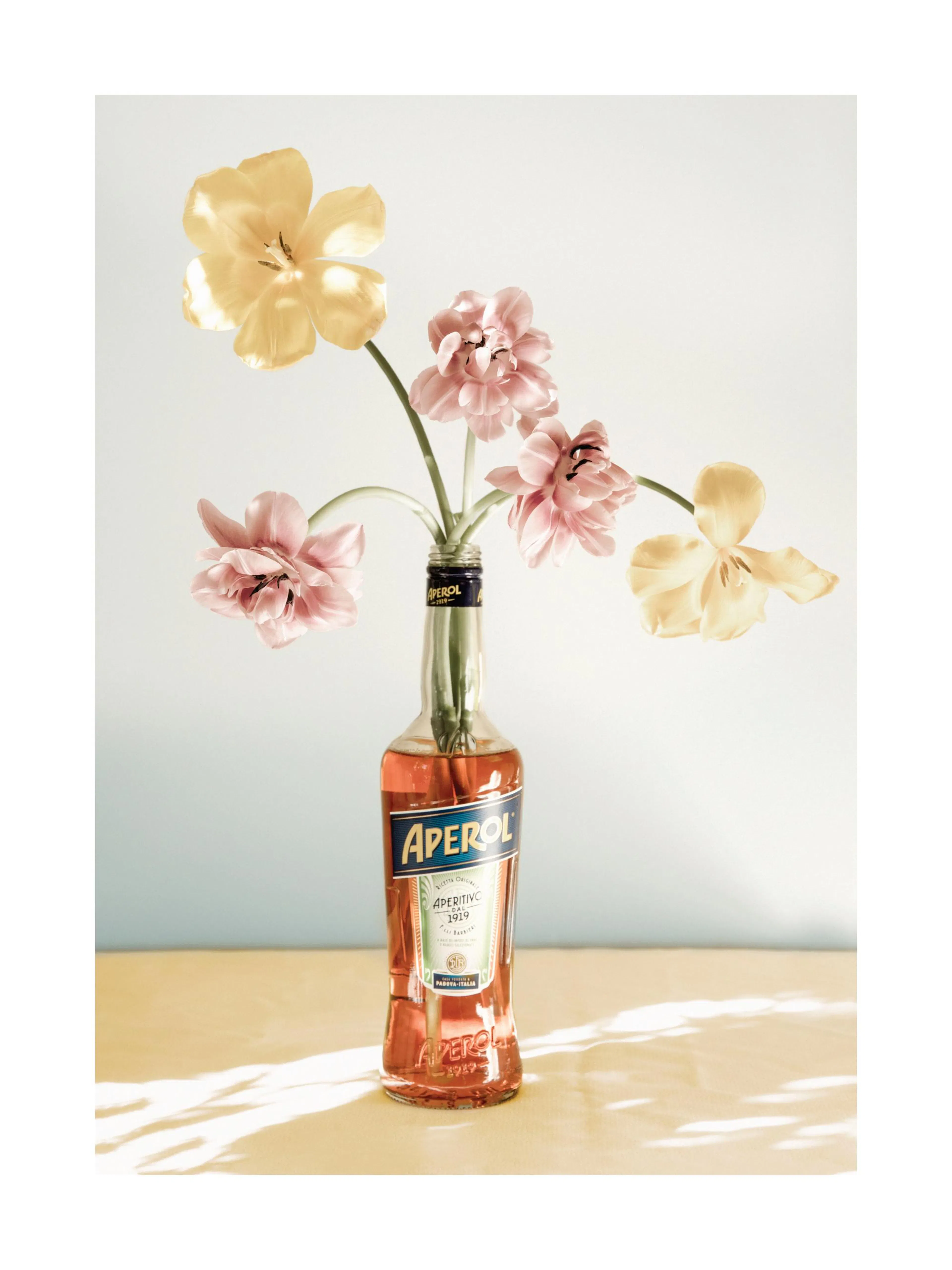 Aperol bottle with yellow and pink flowers, summer bouquet print.