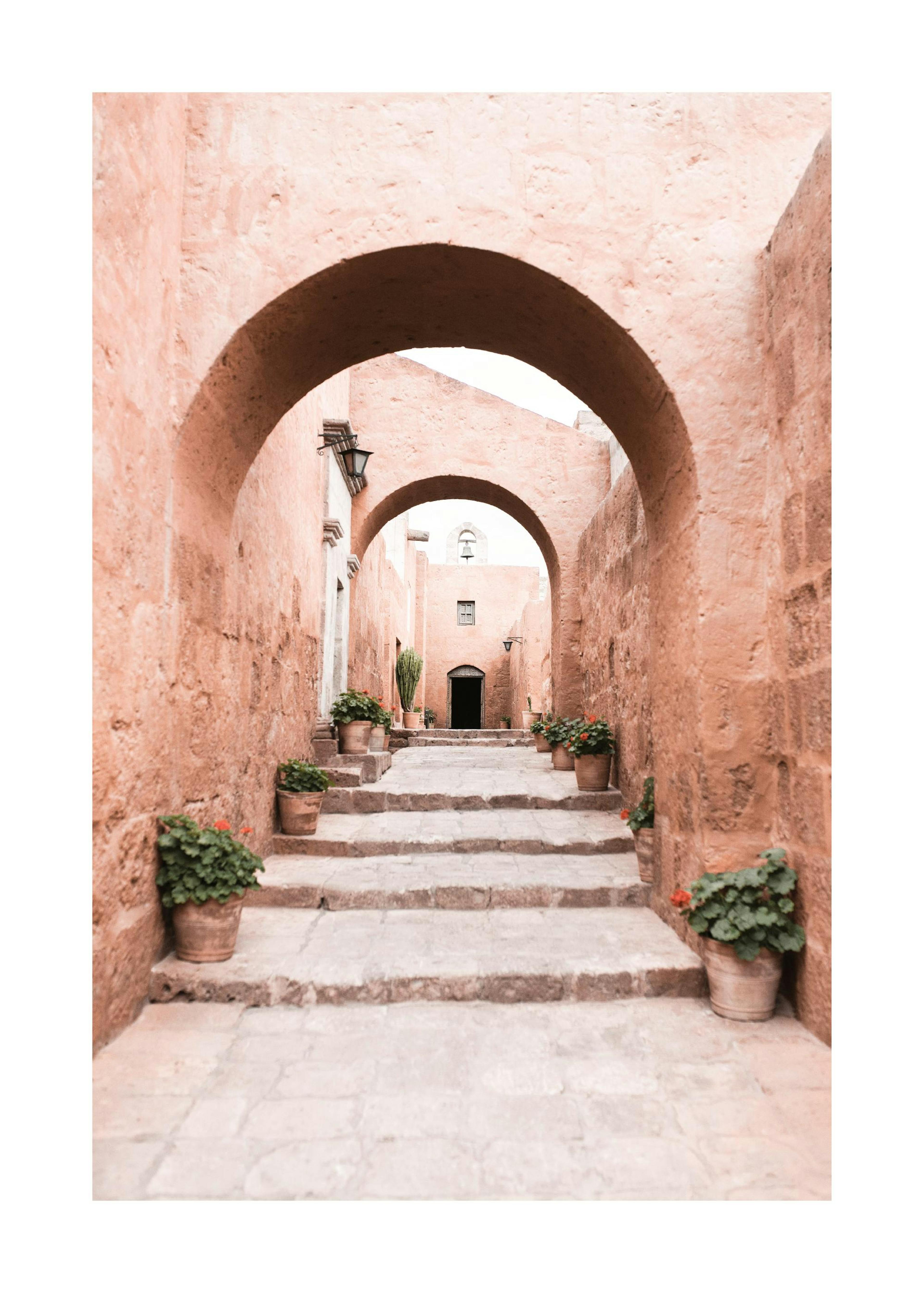 Photograph of Peruvian arches in a calming beige tone with stairs and potted plants, a beautiful print poster.