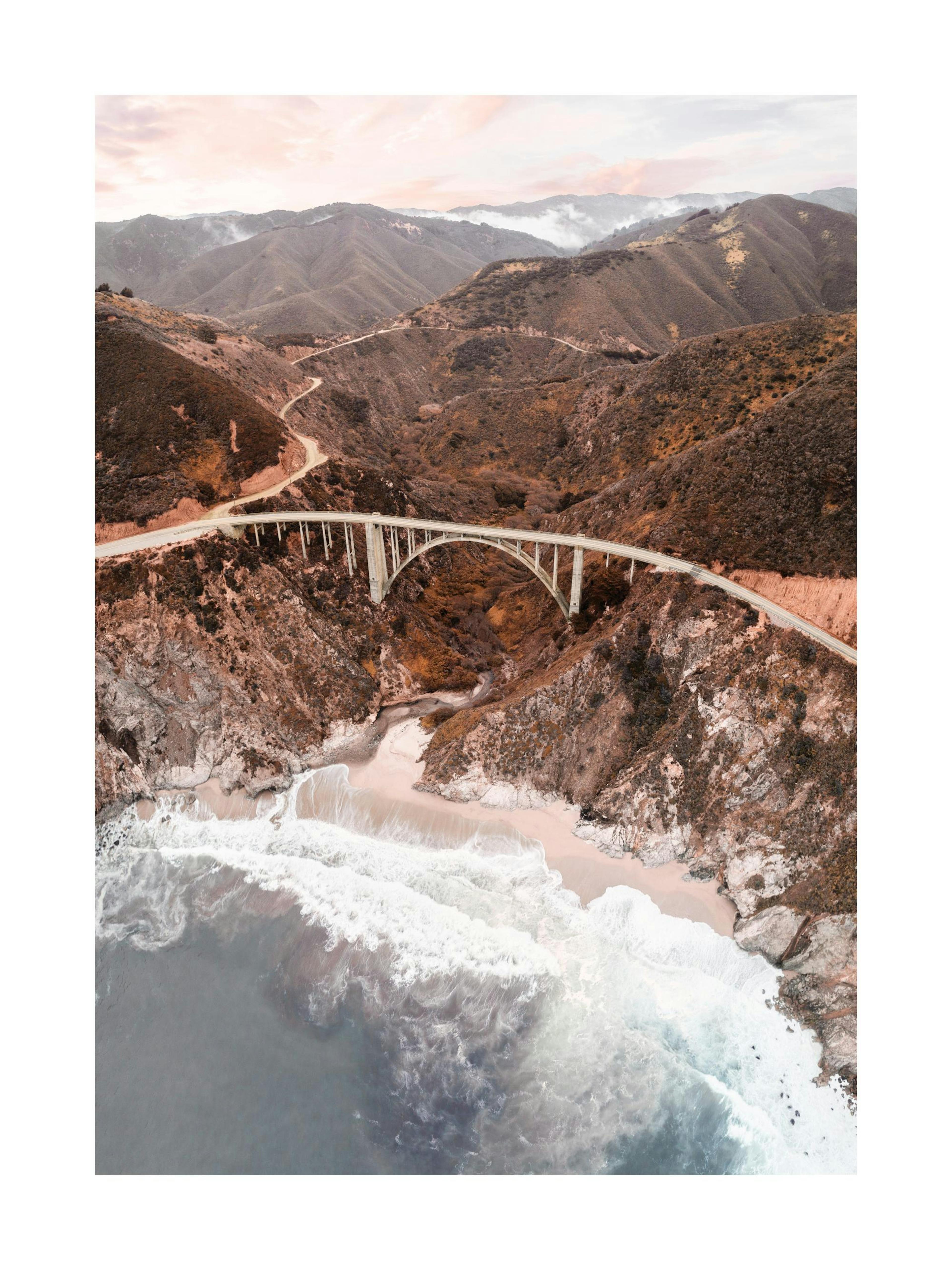 Print of Bixby Creek Bridge over the ocean with mountains and sky, a landscape poster.