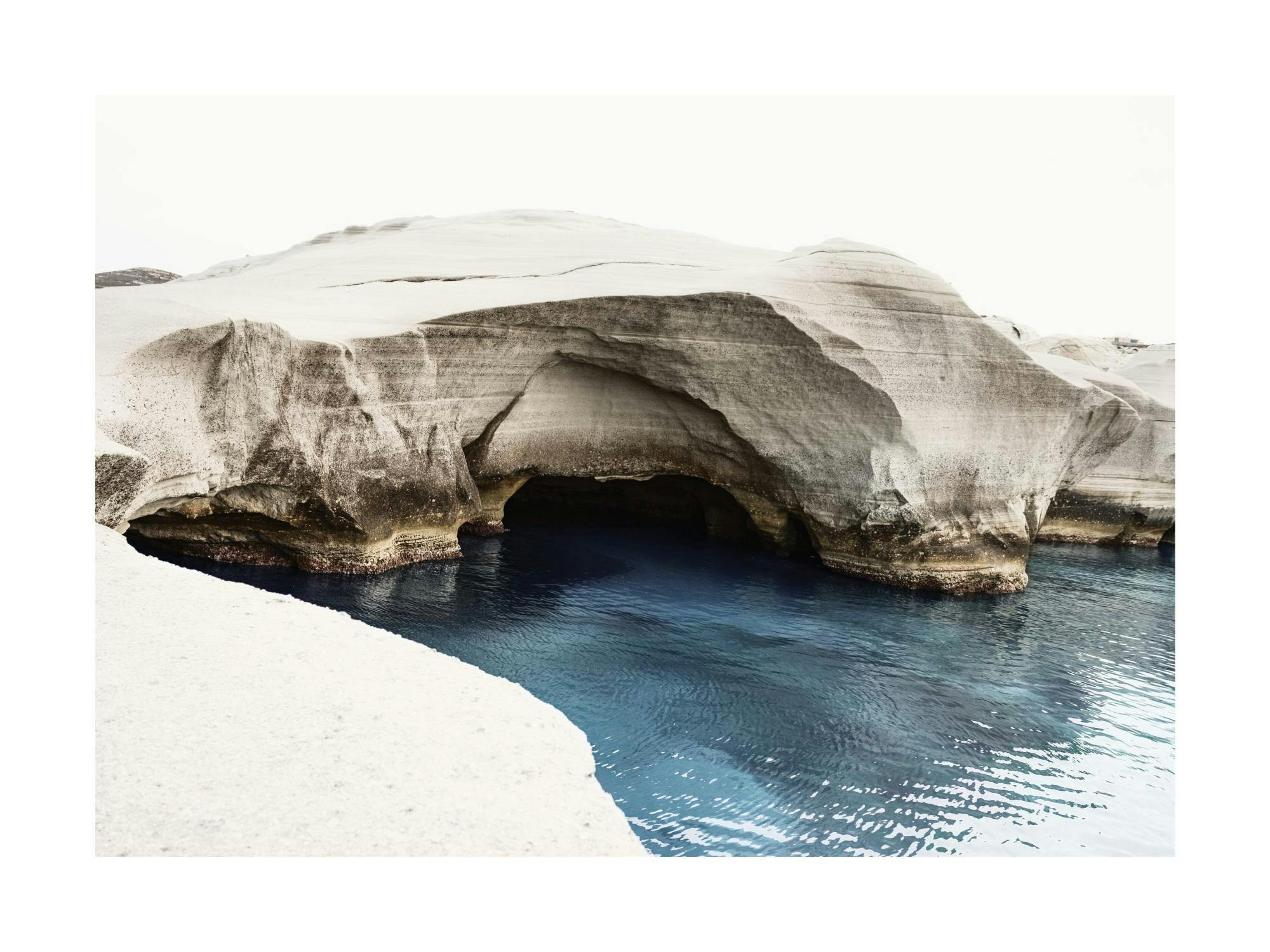Sarakiniko White Cliffs print, featuring white volcanic rock formations and deep blue water. Coastal landscape art poster.