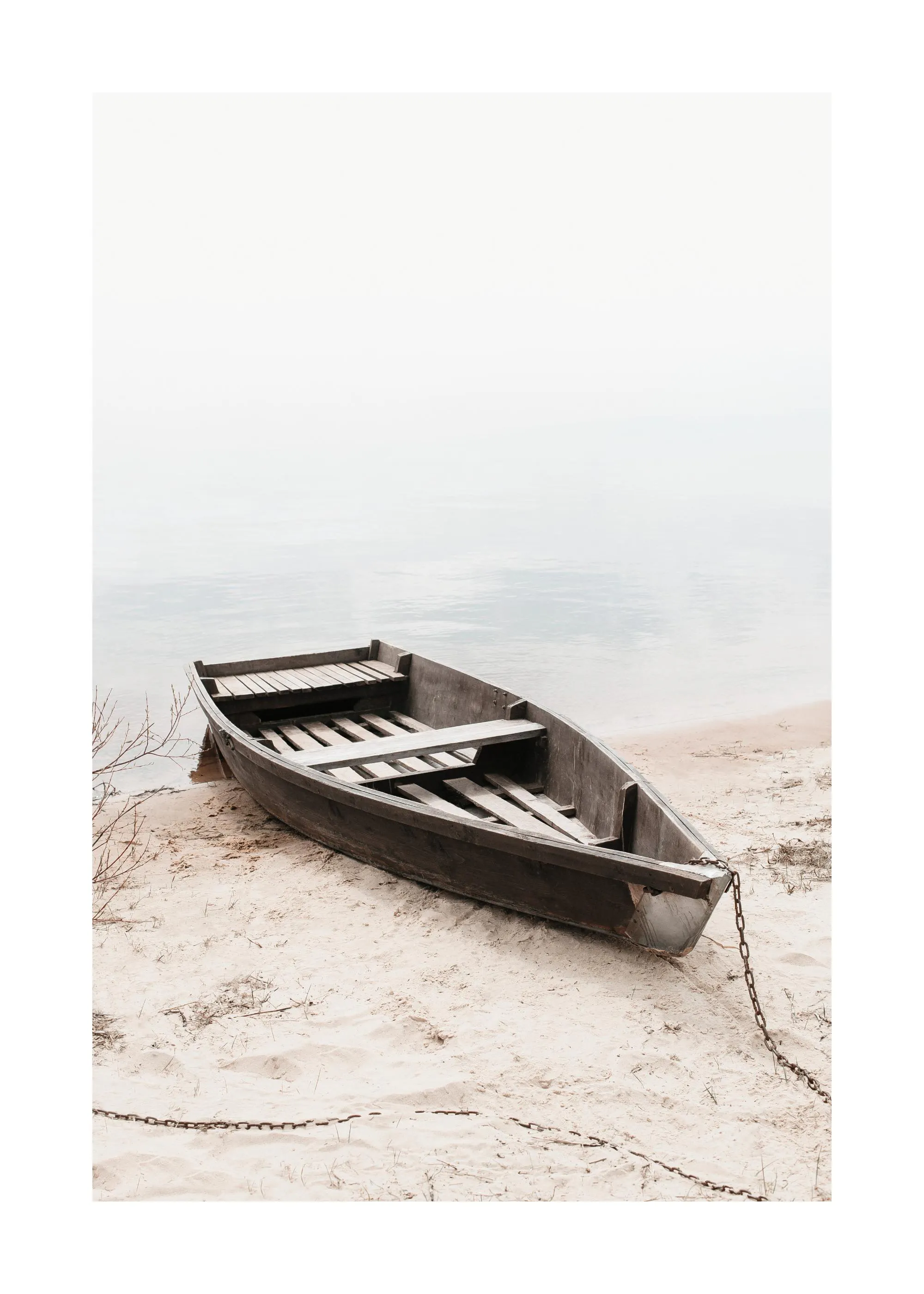 Photography print of a stranded wooden boat on sand with a chain, water in background. Poster print.