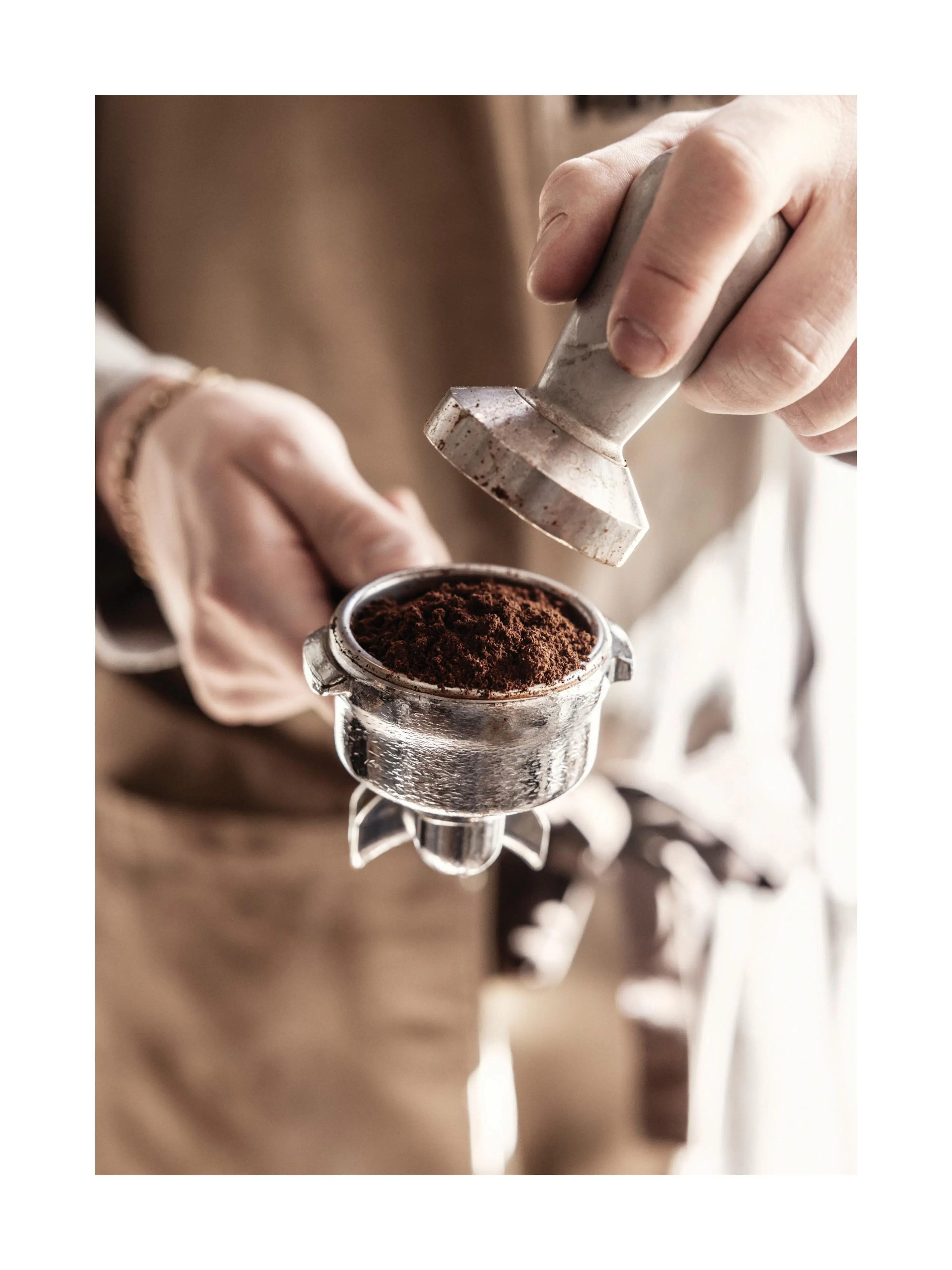 Coffee Grounds Print poster with hand tamping coffee in portafilter, brown and beige tones, kitchen print