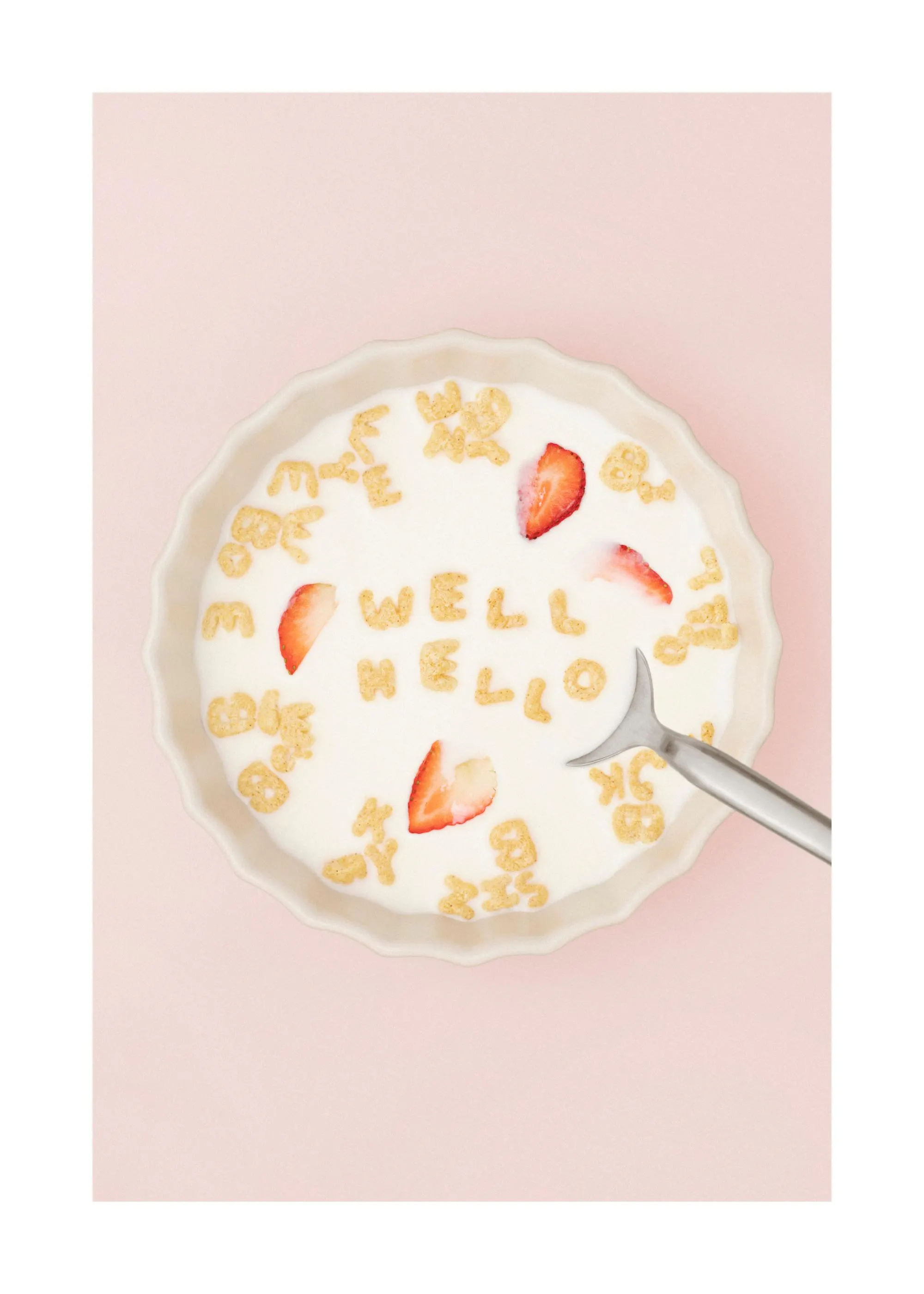 Food photography poster with cereal spelling Well Hello in a bowl of milk with strawberries, pink background.