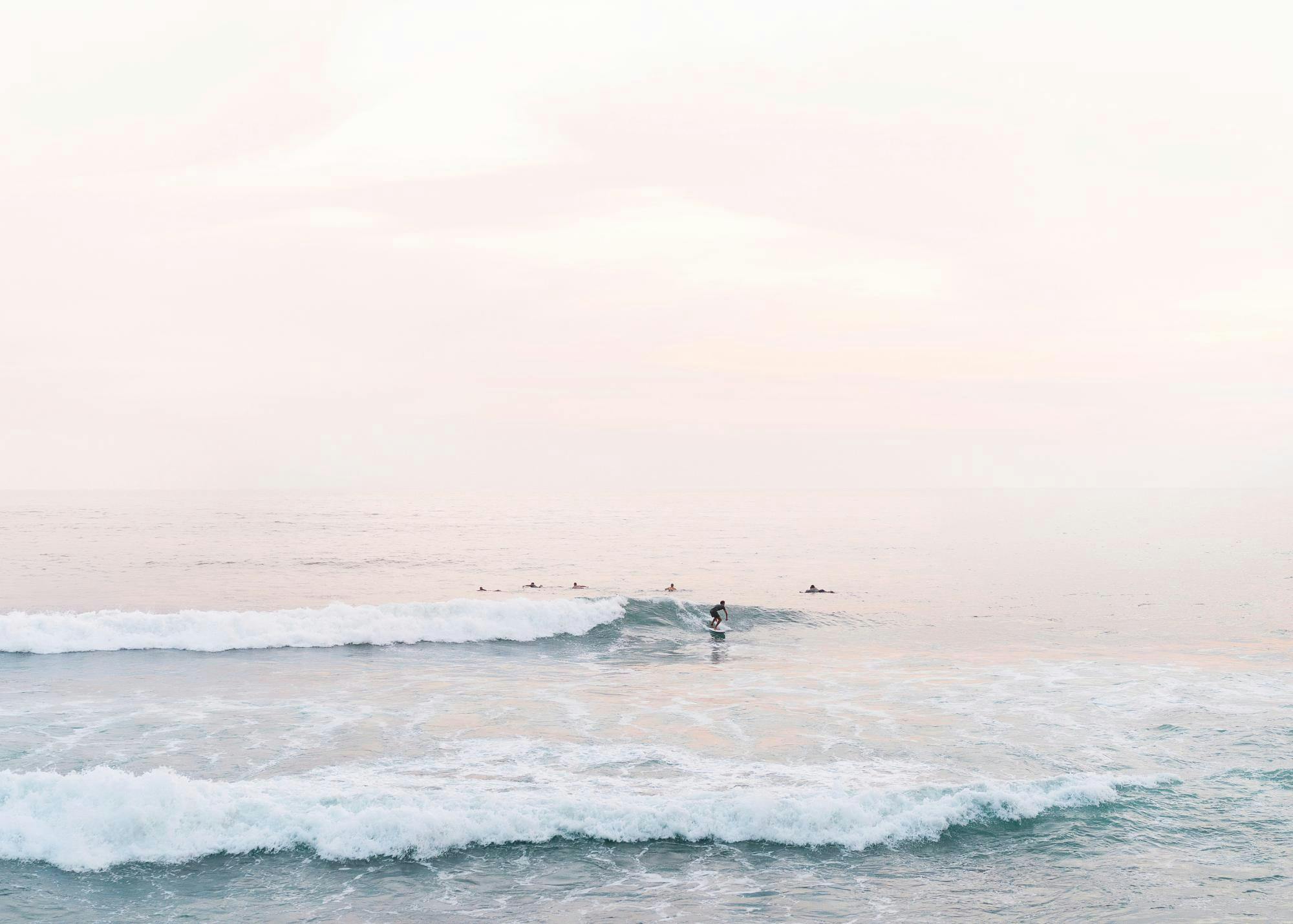Sunrise Surf print poster with surfers in the ocean at dawn
