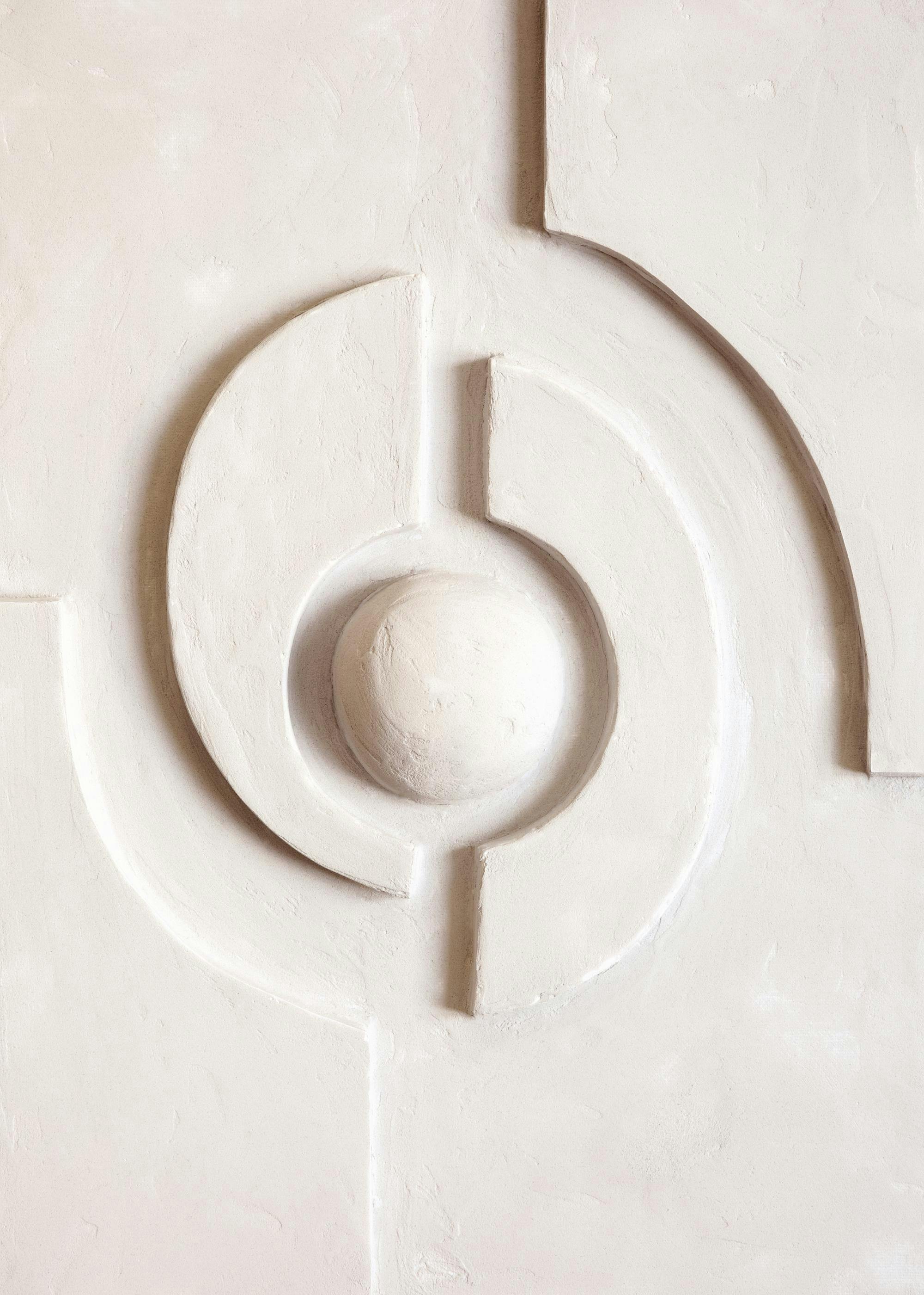 Beige textured wall art with raised geometric design featuring a central sphere and curved lines, creating a subtle 3D effect.