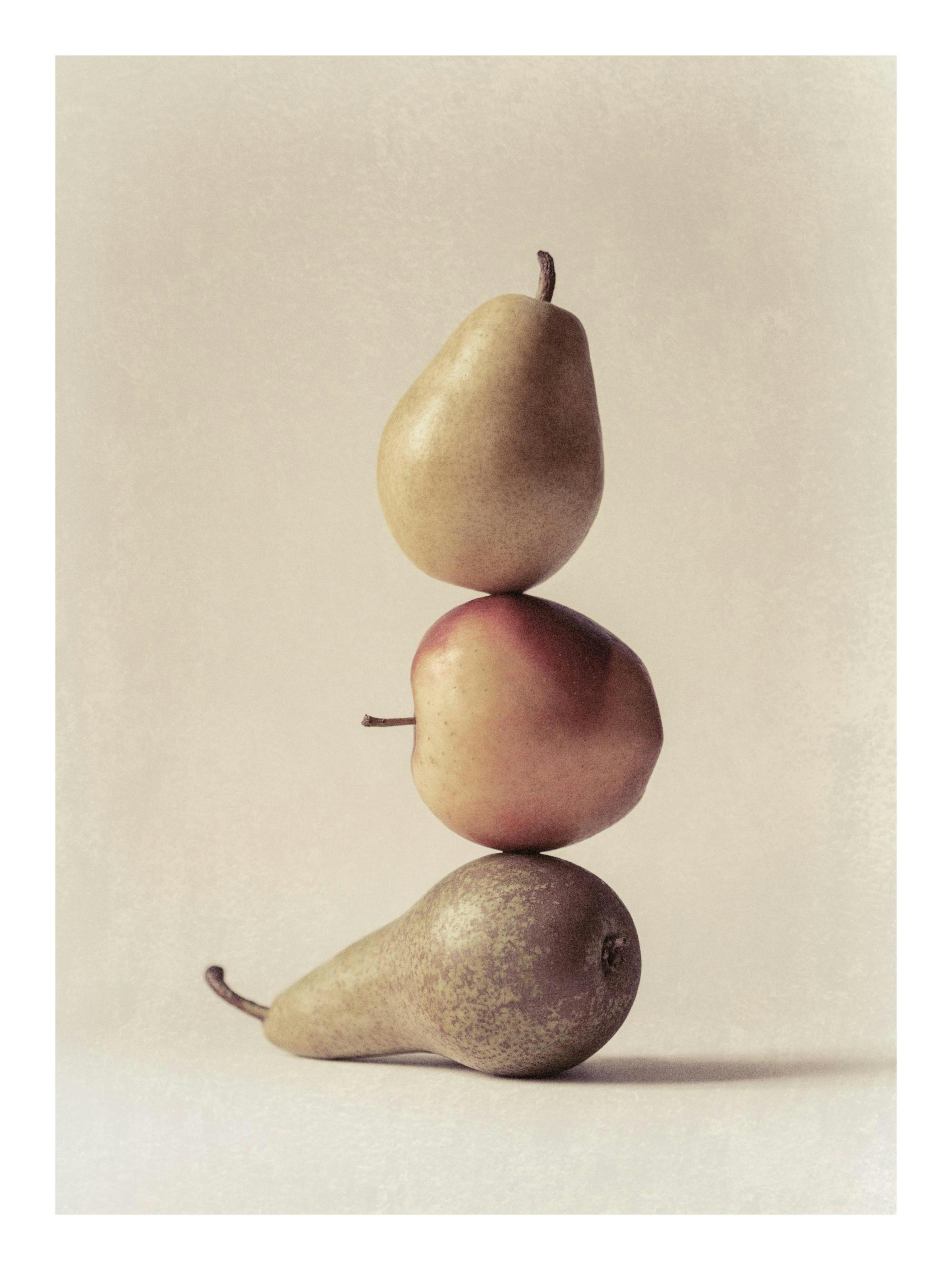 Still life poster with three pears stacked vertically on a beige background, still life art.