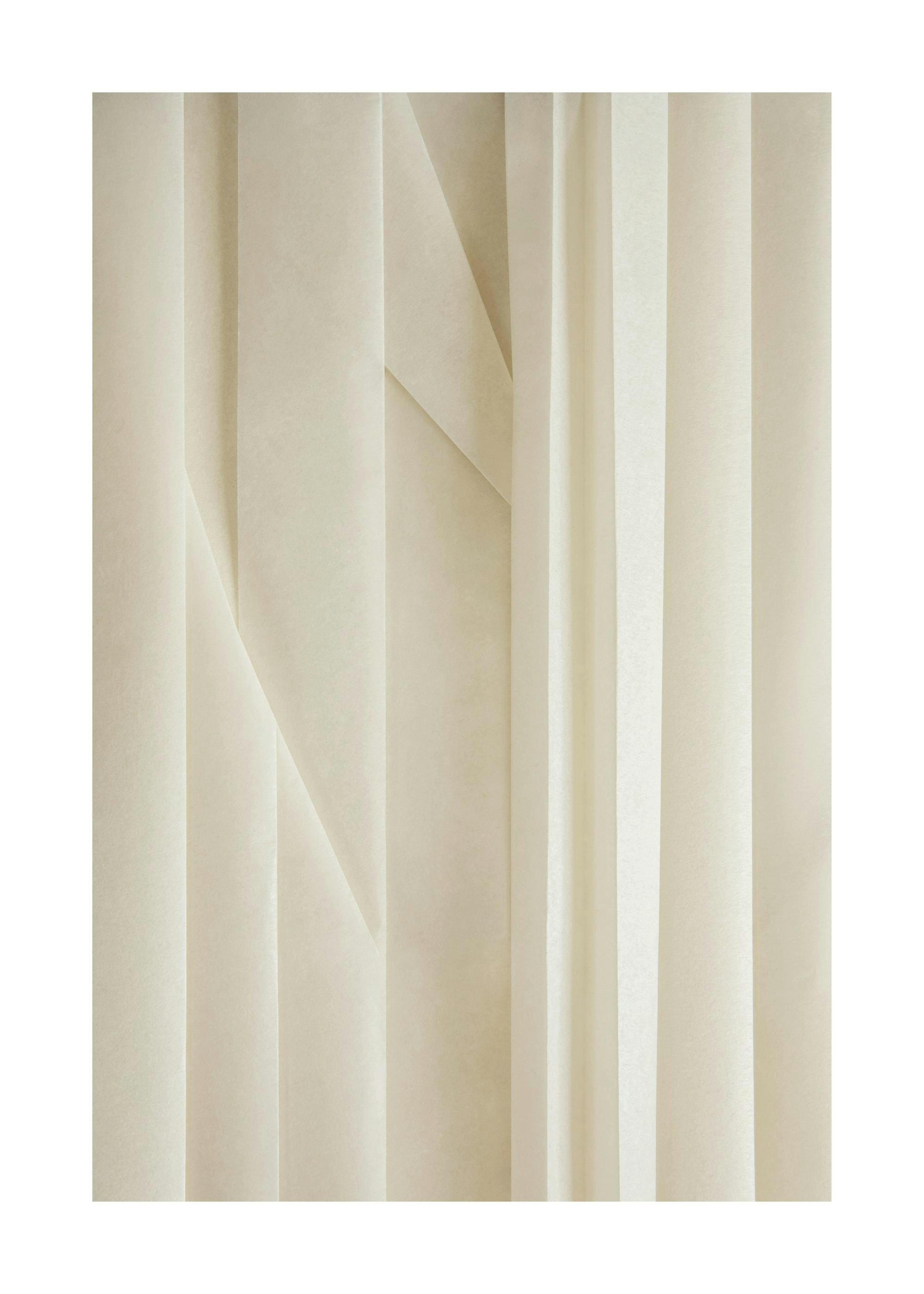 Close-up photo print of rice paper texture poster in creamy white with vertical creases and subtle folds.