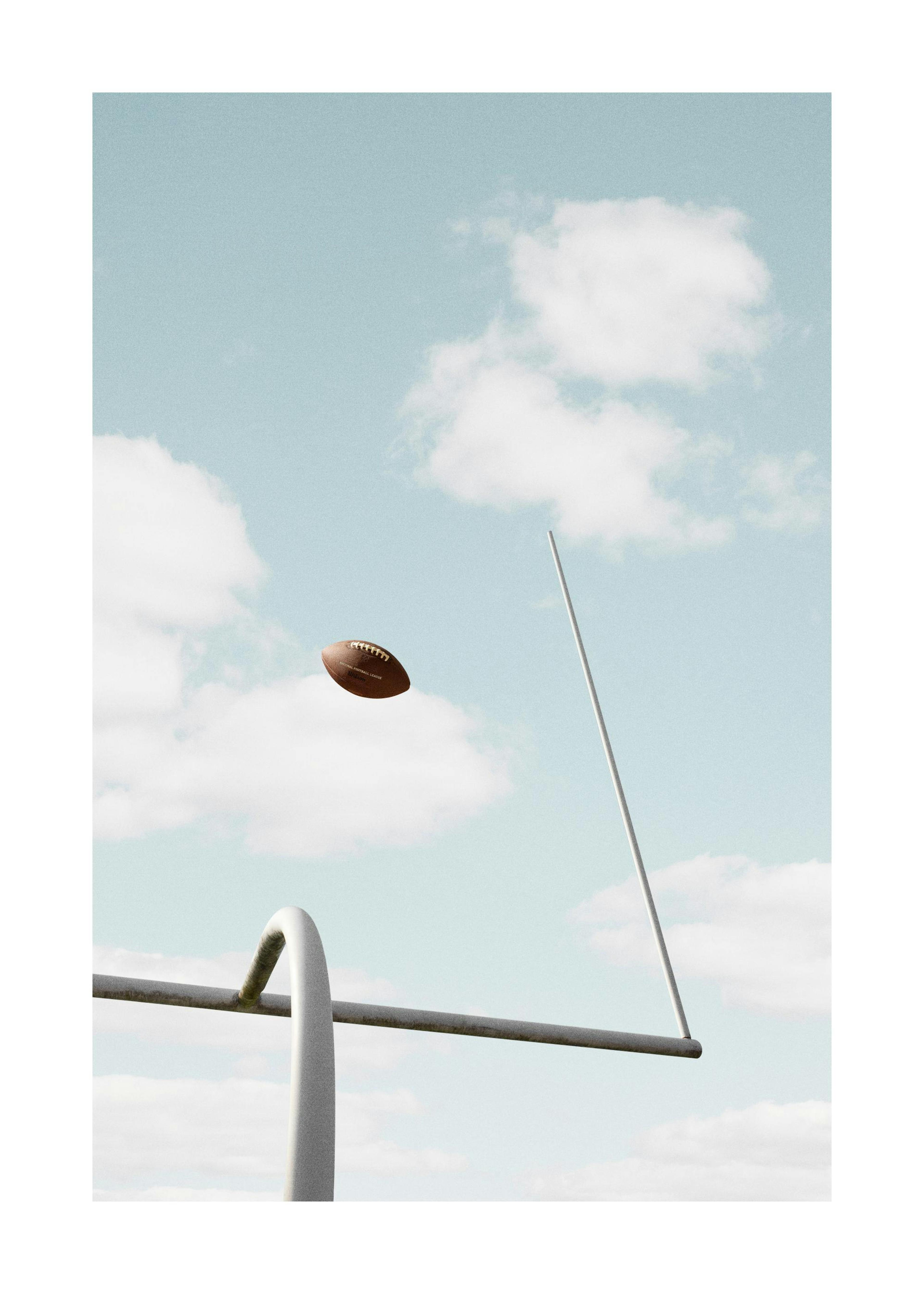 American Football Print, football flying through goalposts against a cloudy blue sky. Photo poster.