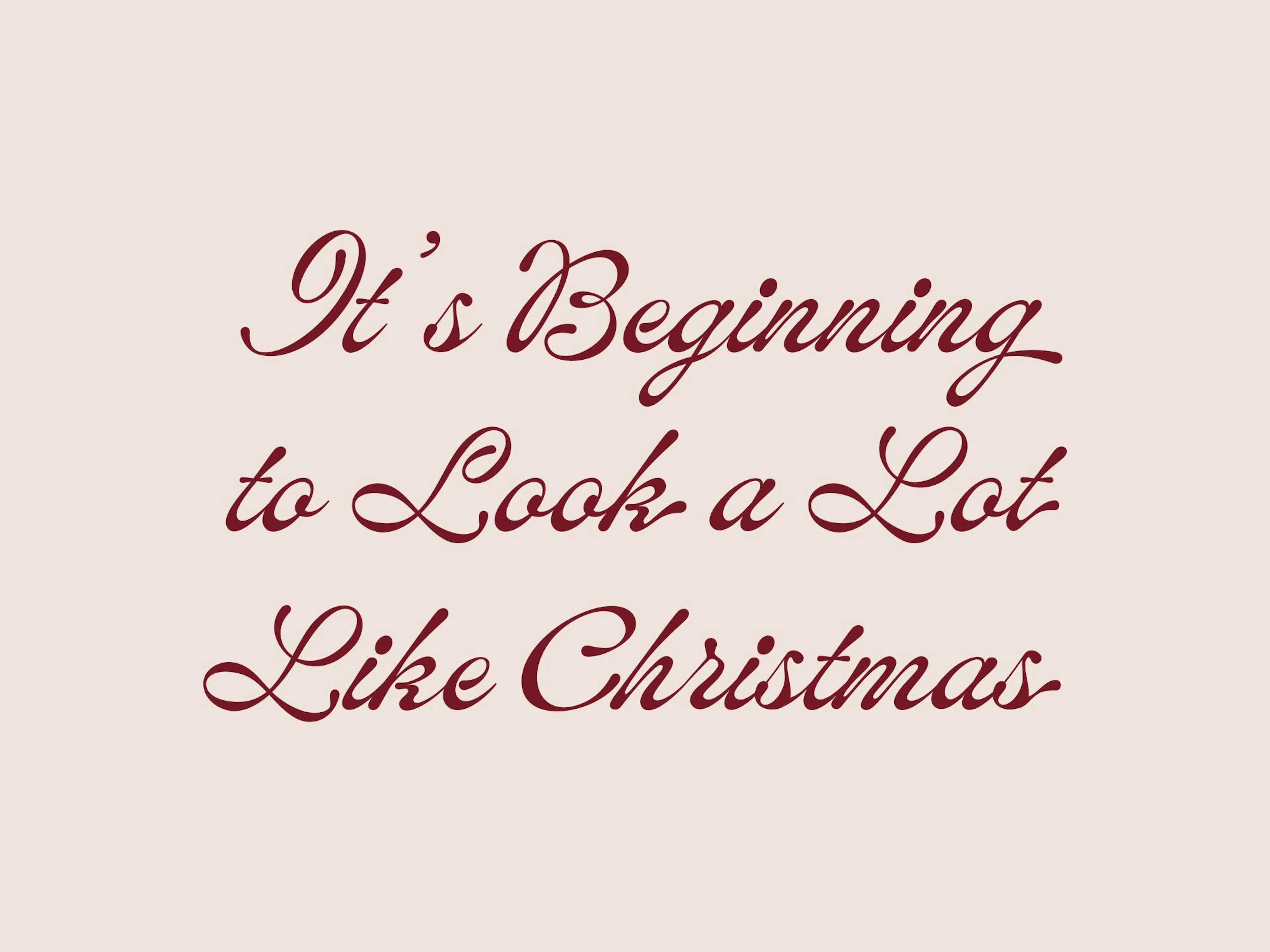 Christmas print with Its Beginning to Look a Lot Like Christmas in dark red cursive on cream background