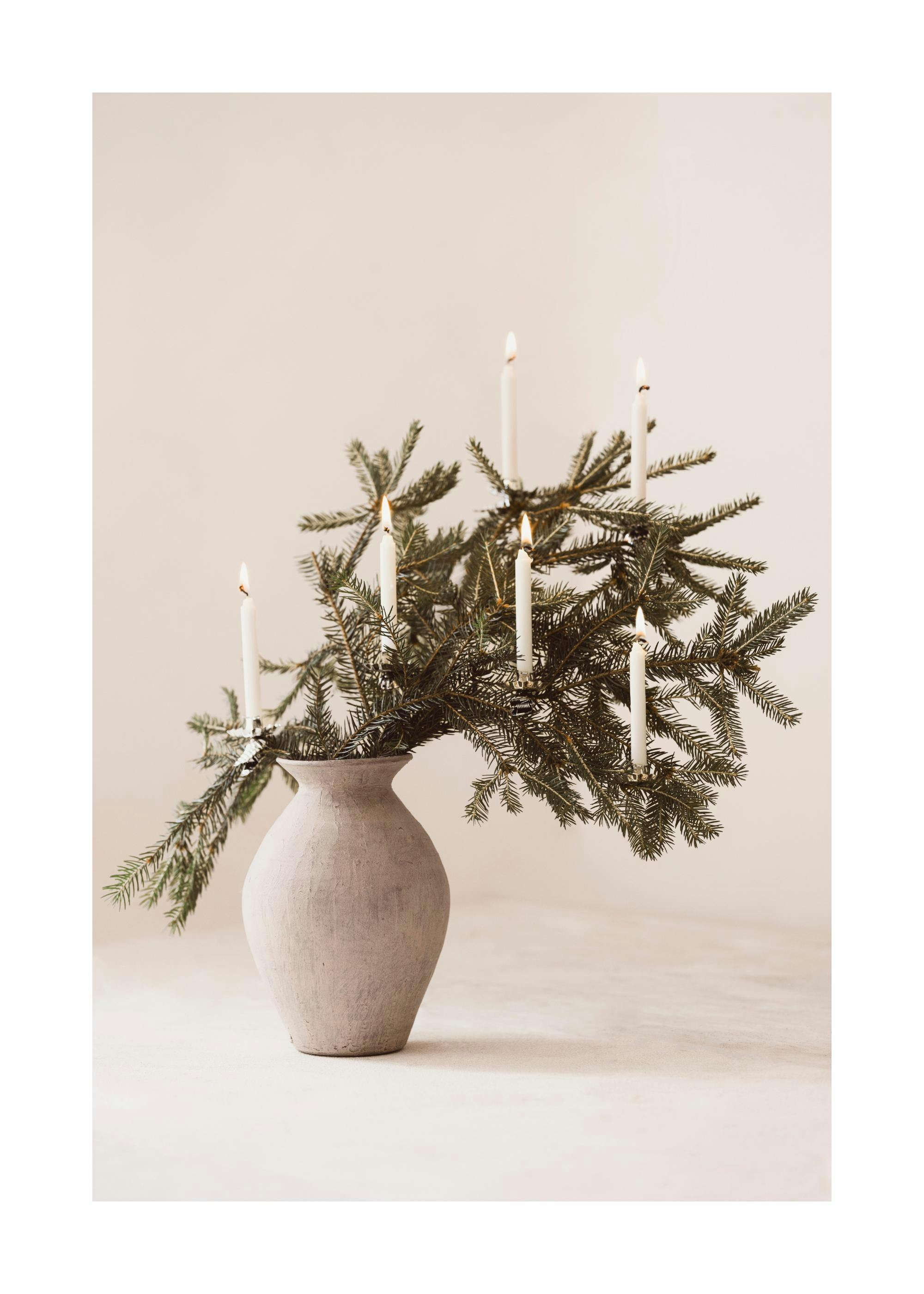 Γκρι βάζο με κλαδιά πεύκου και αναμμένα λευκά κεριά, Σκανδιναβική ατμόσφαιρα
