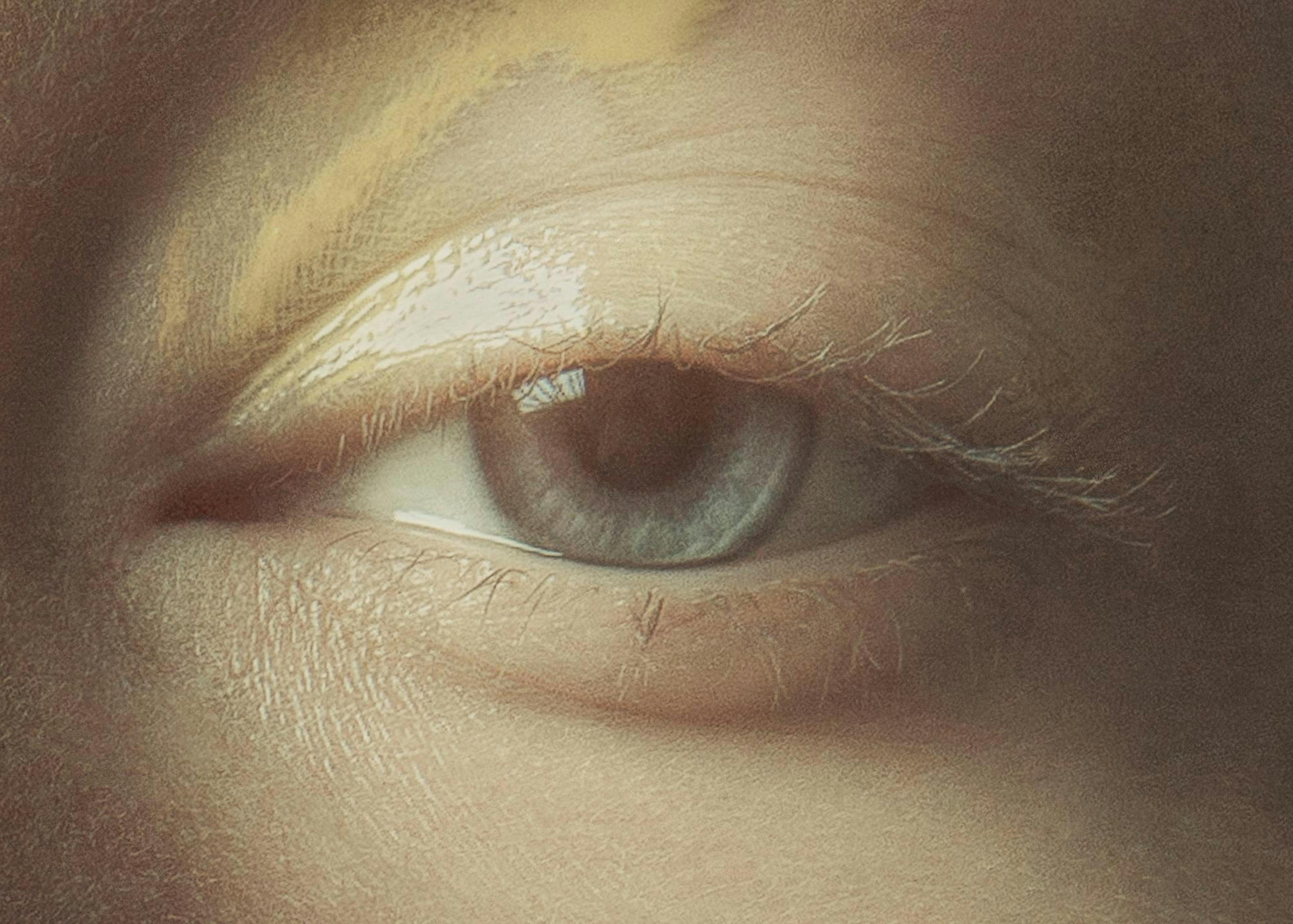 Detailed close-up print of a light blue eye with visible skin texture and faint eyelashes.