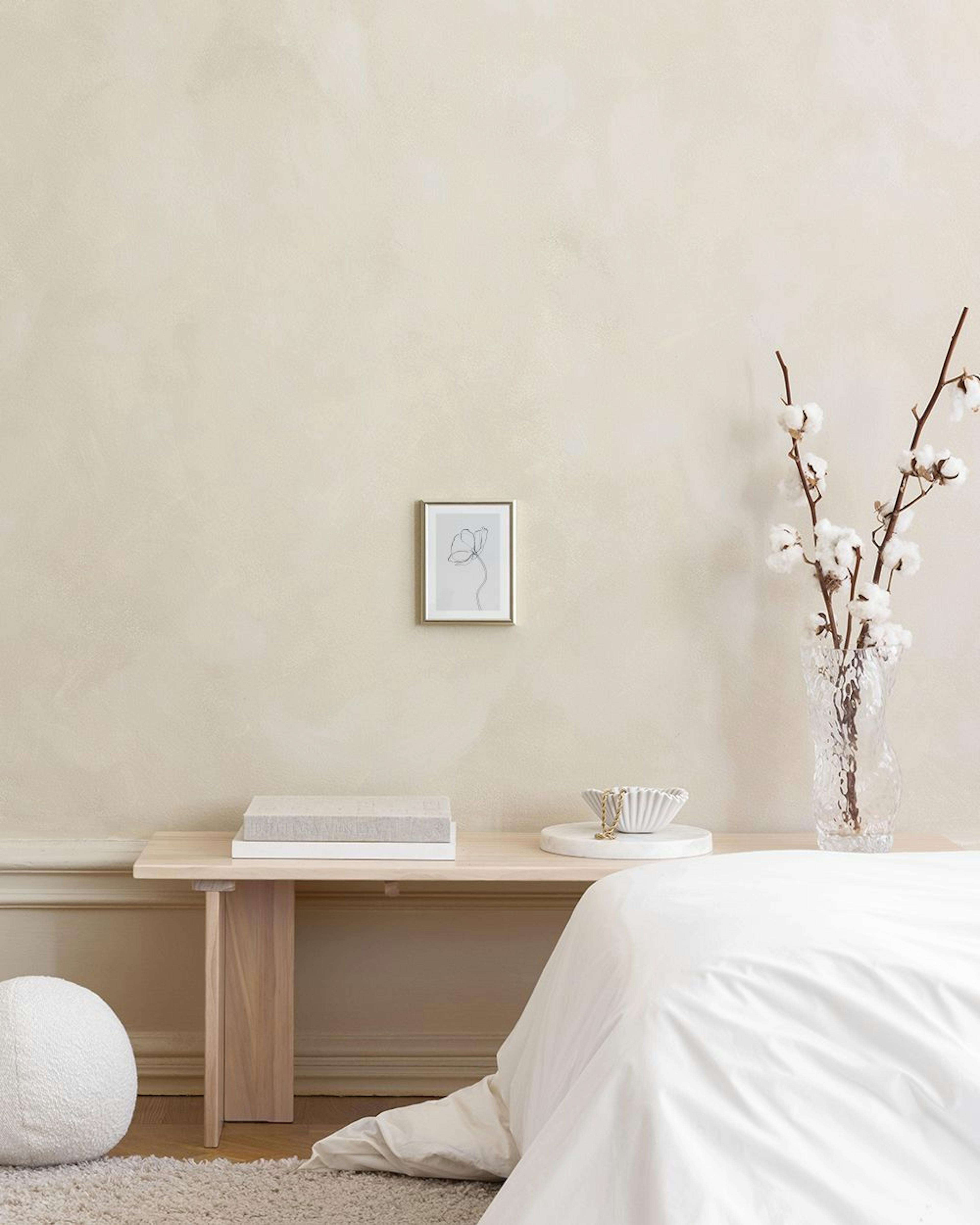 Poster mit gezeichneter Blume, minimalistischer Linienkunst, über einem weissen Sideboard im Wohnzimmer.