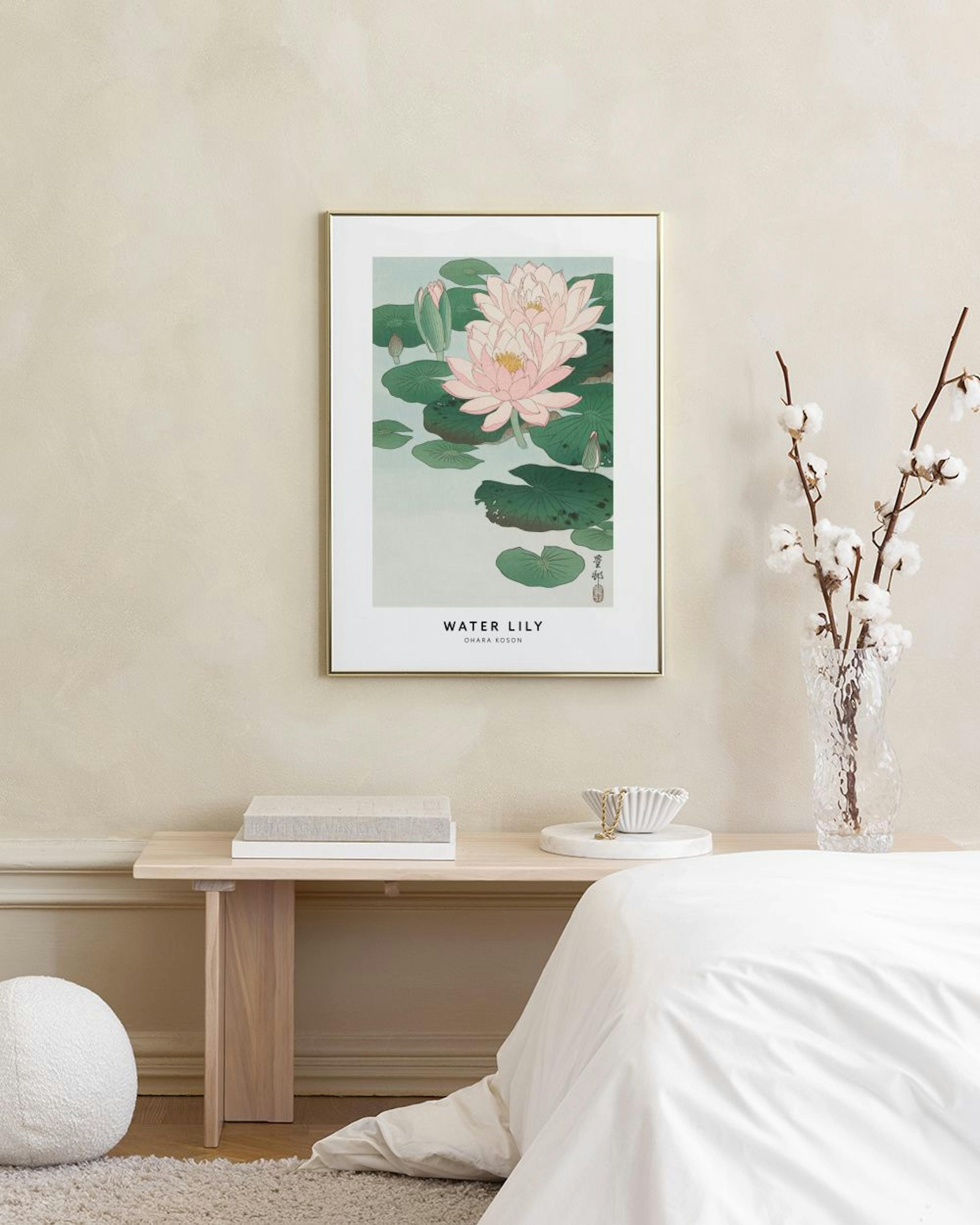 A water lily print with pink flowers and green leaves, displayed on a concrete bench with decorative spheres and a white lamp.