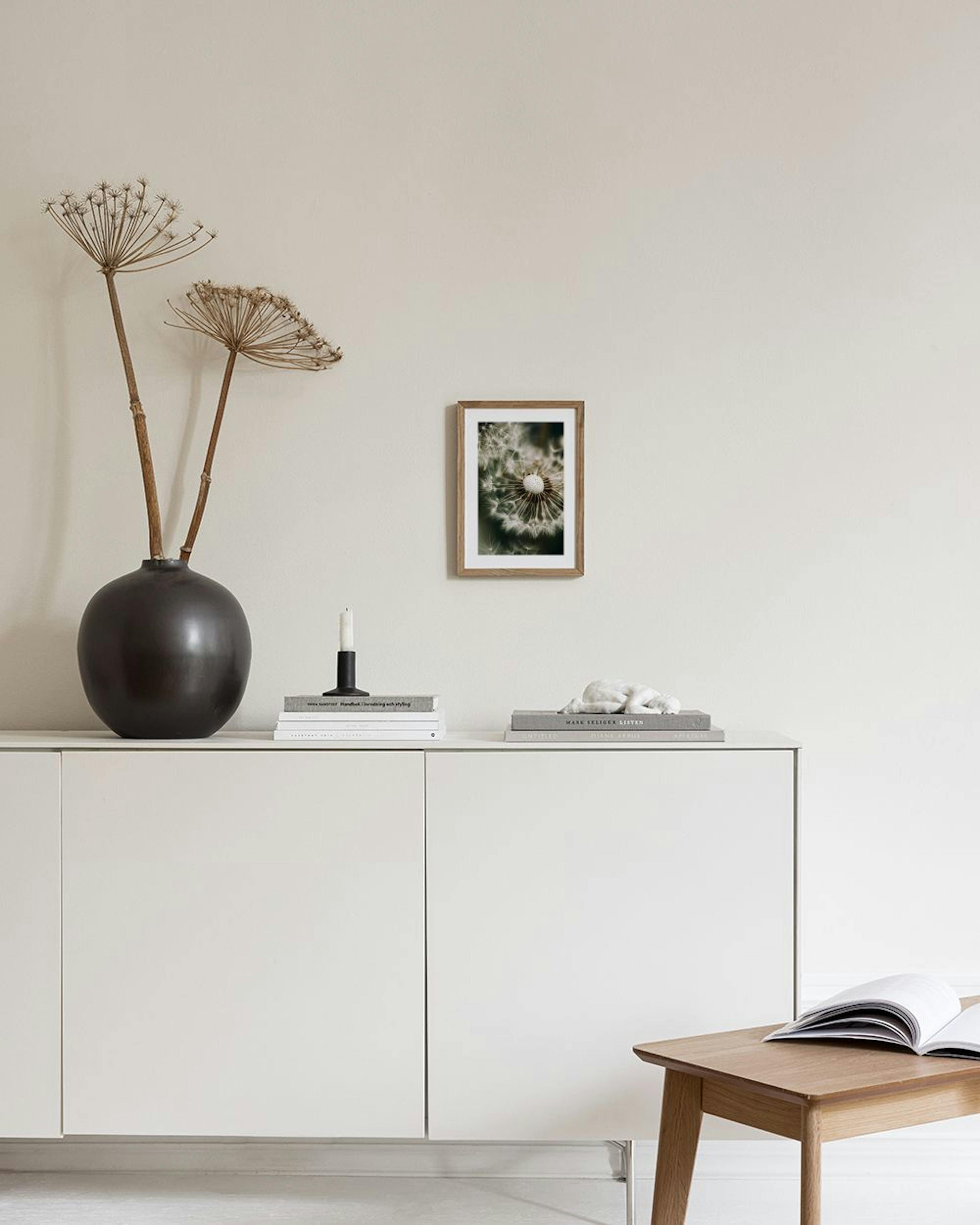 Affiche macro dun pissenlit en gros plan, suspendue au-dessus dune table basse avec des vases.