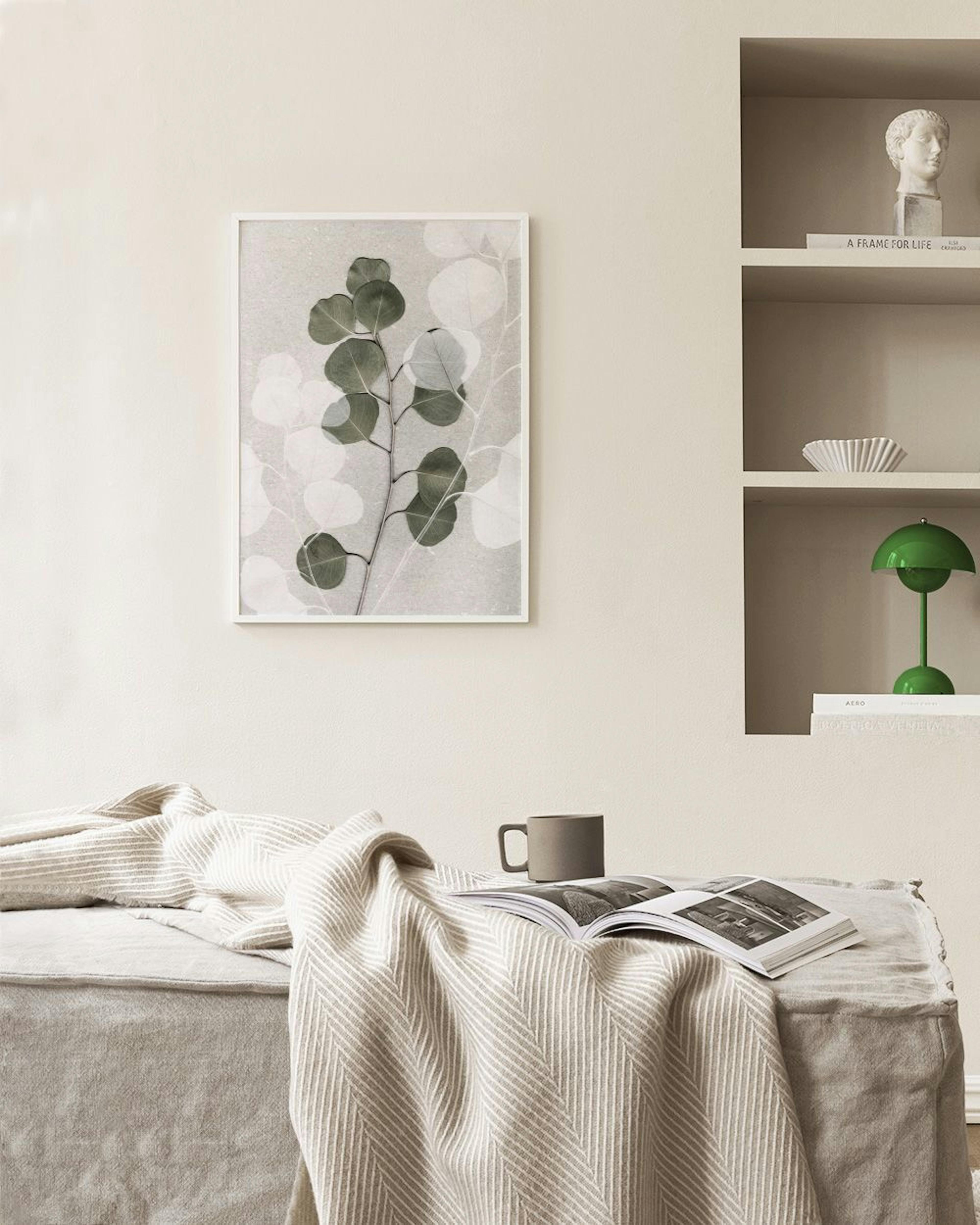 A botanical print featuring dark green eucalyptus leaves and translucent white leaves on a light grey background, displayed abov