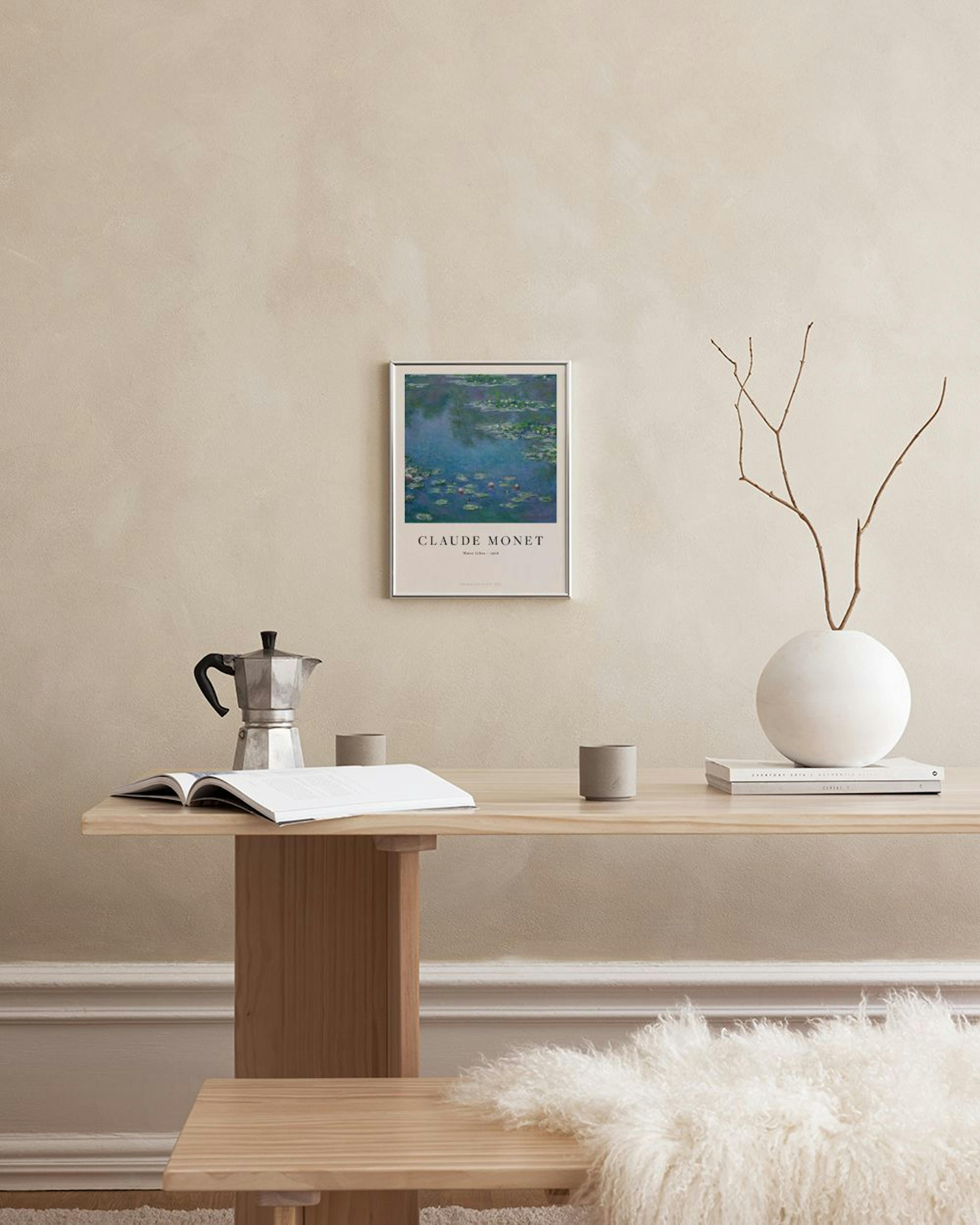 Claude Monet Water Lilies print hanging on a gray wall above a white cabinet with decorative vases and books.