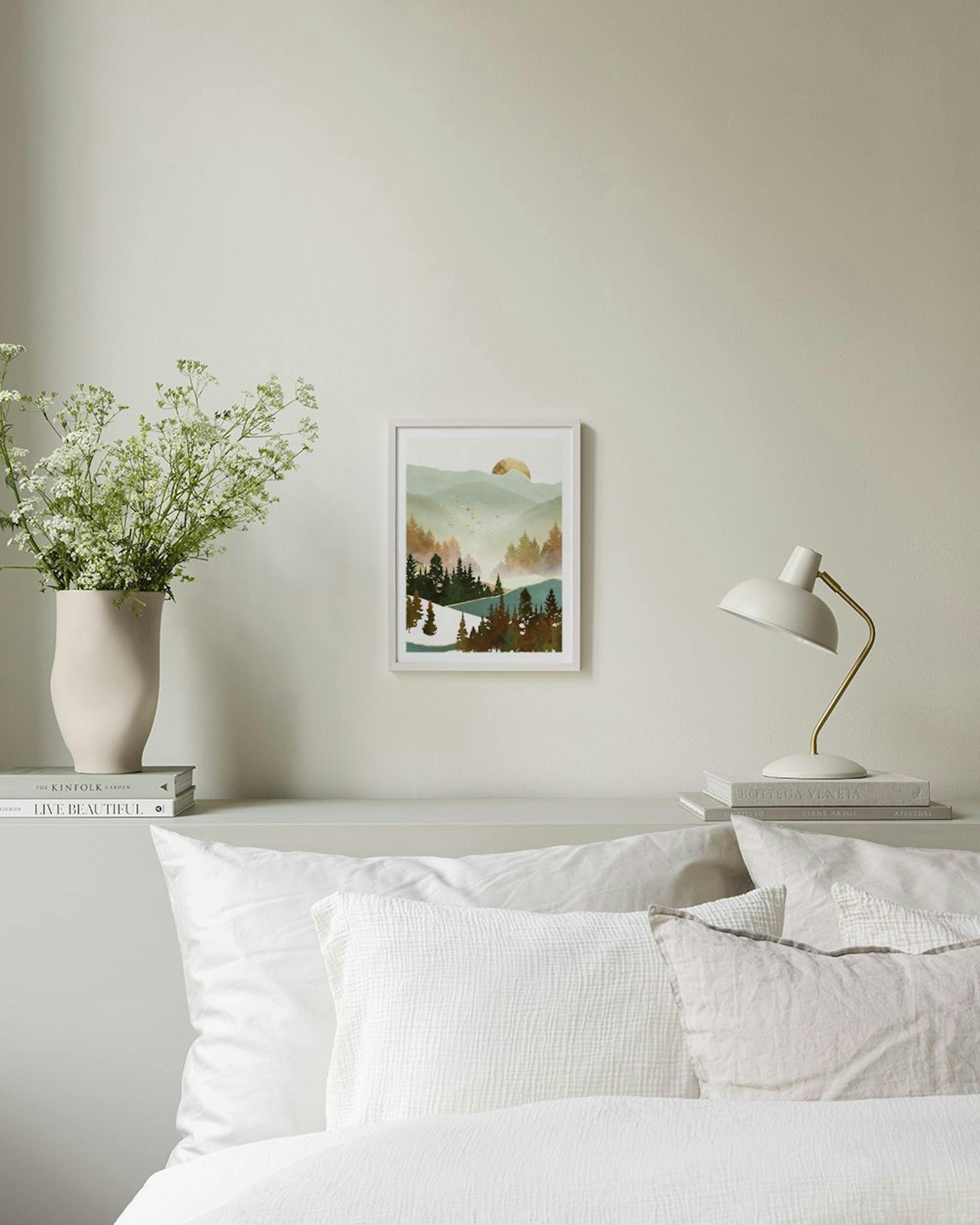 A print of a misty mountain forest landscape with a golden sun, hanging above a bed with an open book.
