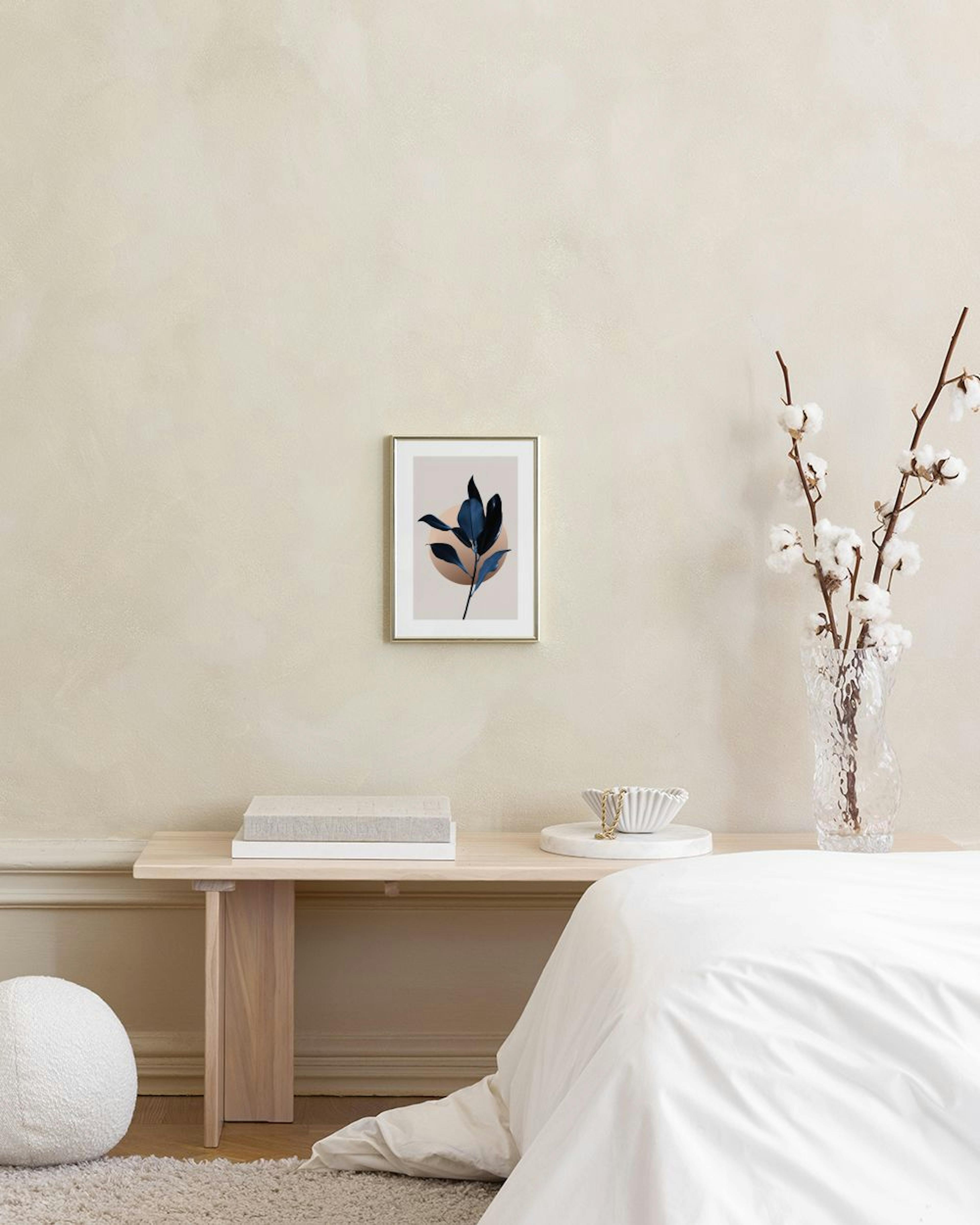 A poster of dark blue leaves on a light background with a brown circle, displayed in a living room above a wooden table.