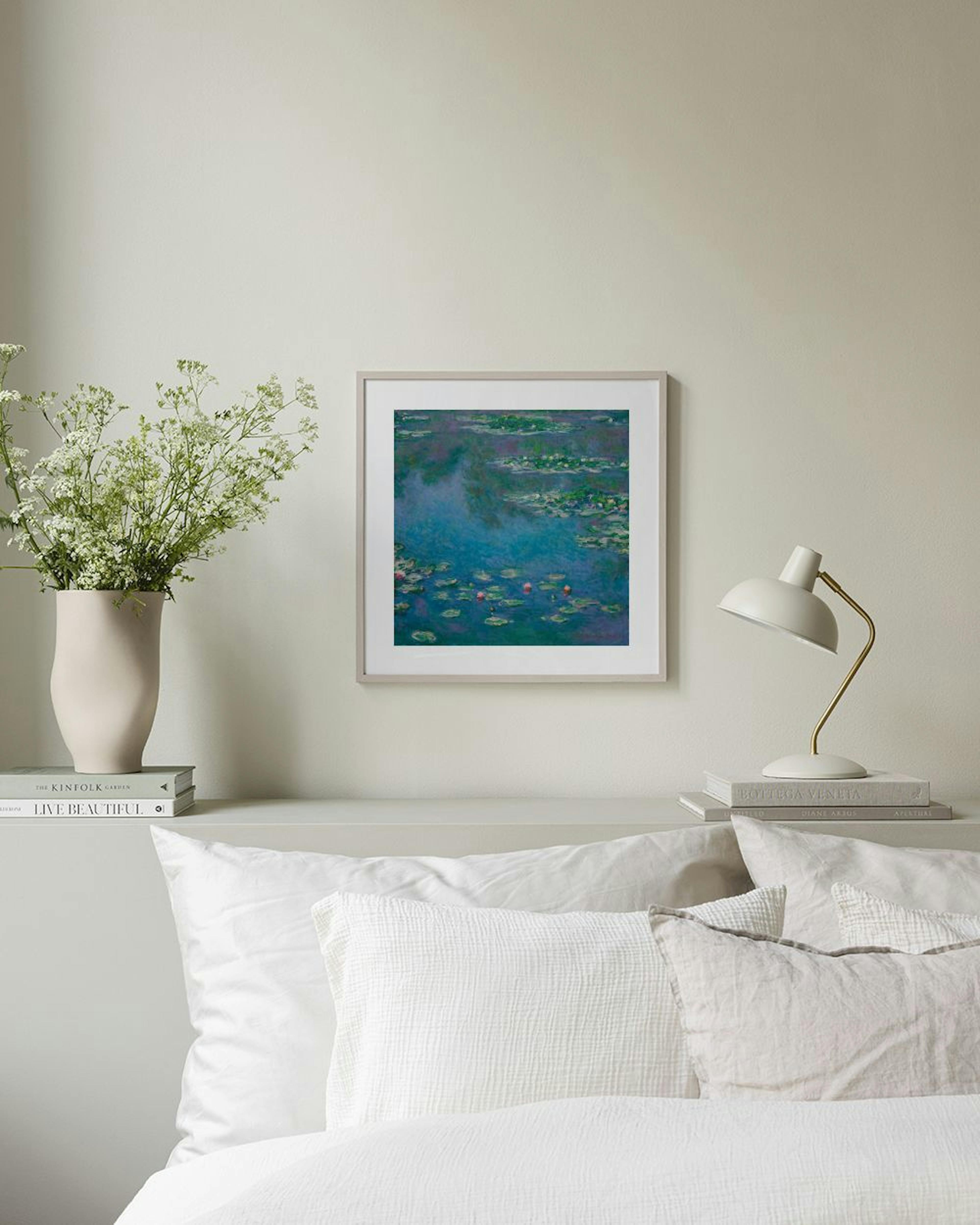 Monets Water Lilies print in deep blues and greens, displayed above a black console table in a living room.